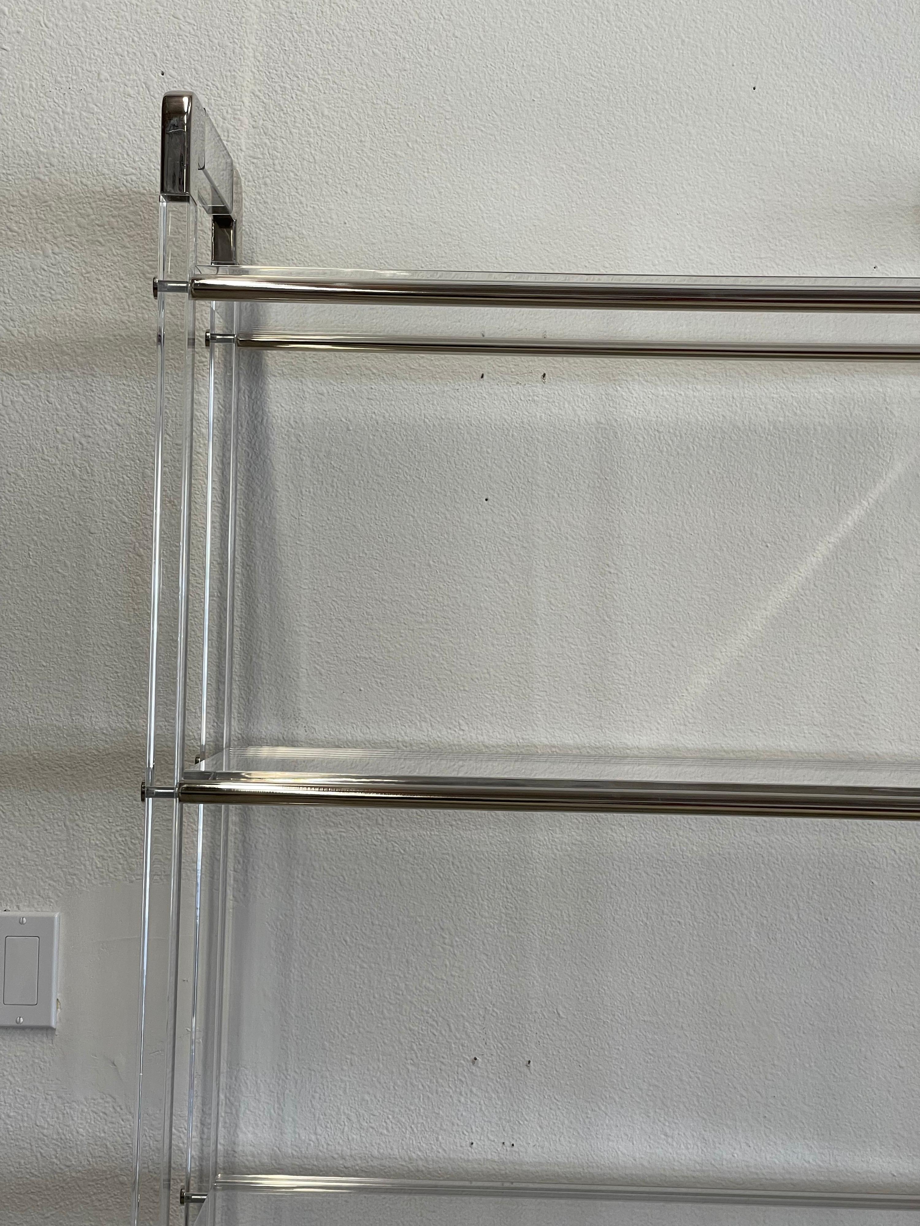 Charles Hollis Jones lucite and nickel etagere with 5 shelves. The shelves are lucite as well. Nice form. The shelves fit with a groove carved into the bottom of each piece of lucite. In good condition with only minimal wear and marks. This piece