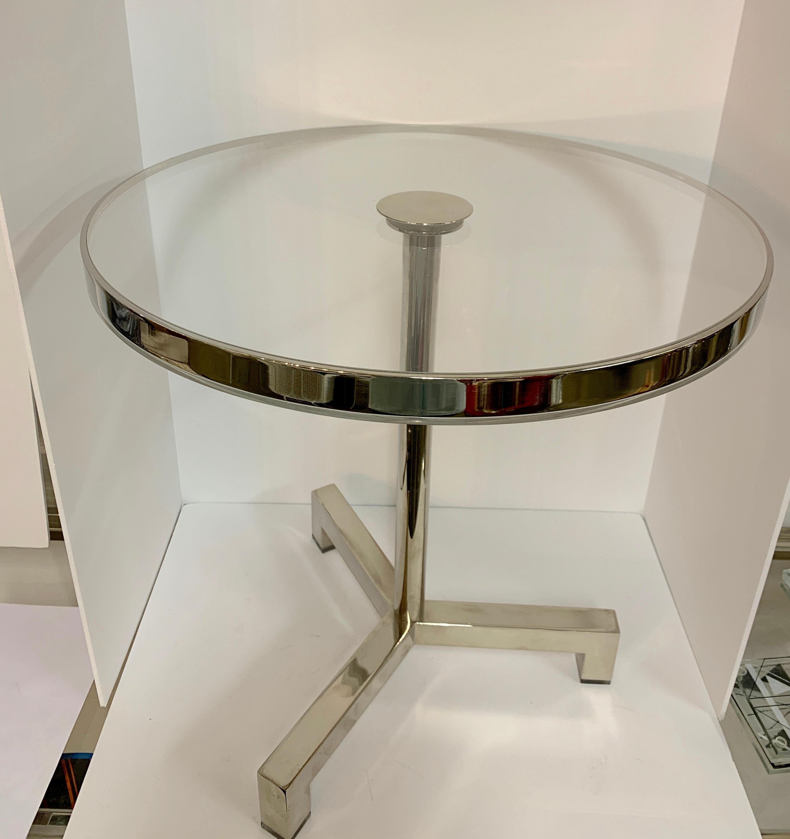 A nicely designed side table by Charles Hollis Jones. Purchased from Mr. Jones. It is a vintage table that has a new top and has been polished and cleaned up. The legs feature Lucite feet. There is a band of nickel around the edge. A nice design.