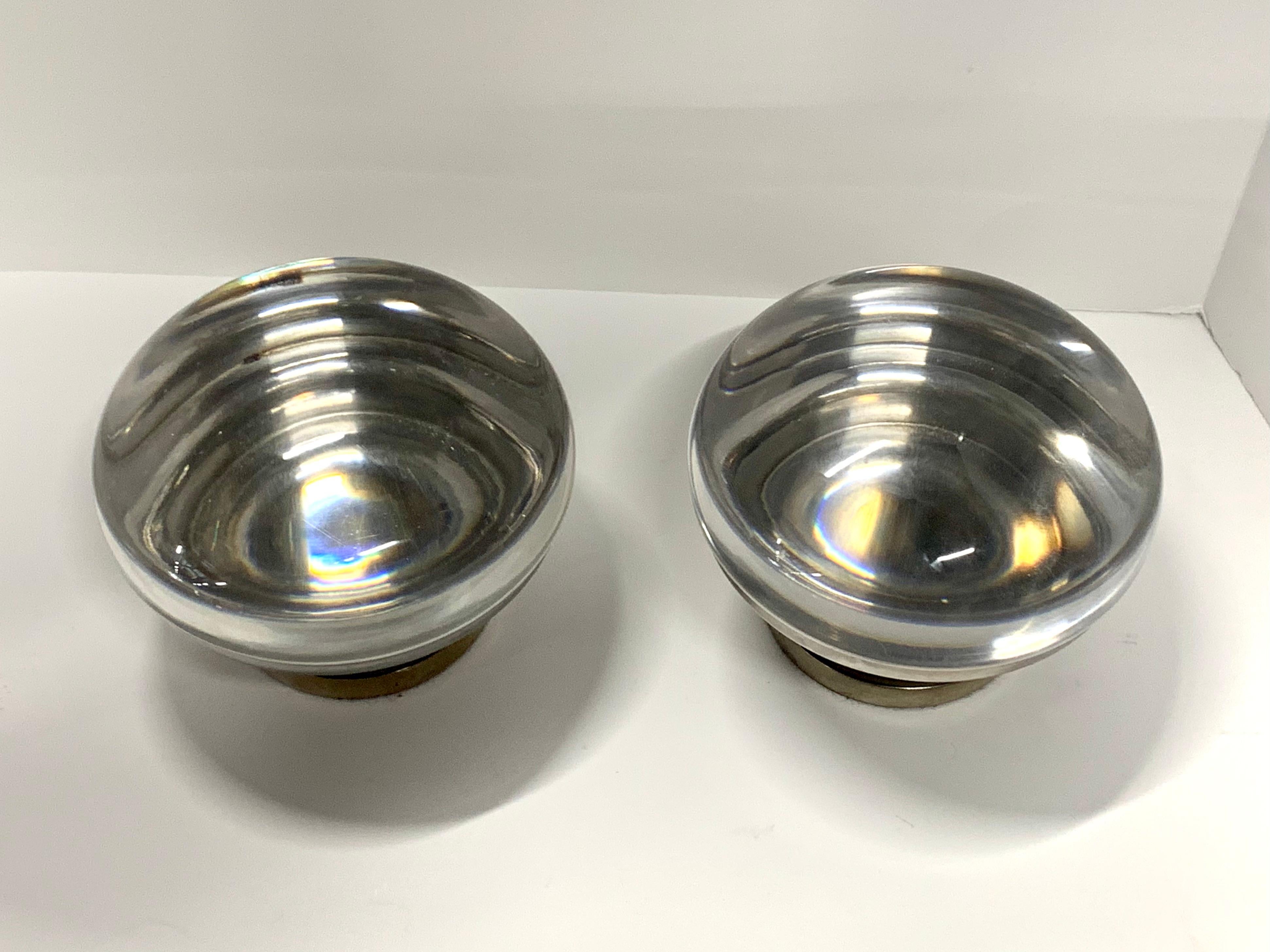 A pair of vintage Charles Hollis Jones magnifying covered vessels in Lucite and nickel finish. Measure approximate: 6 inches in diameter and 5 inches tall. In good vintage condition with minor marks throughout. These were purchased from Mr. Jones