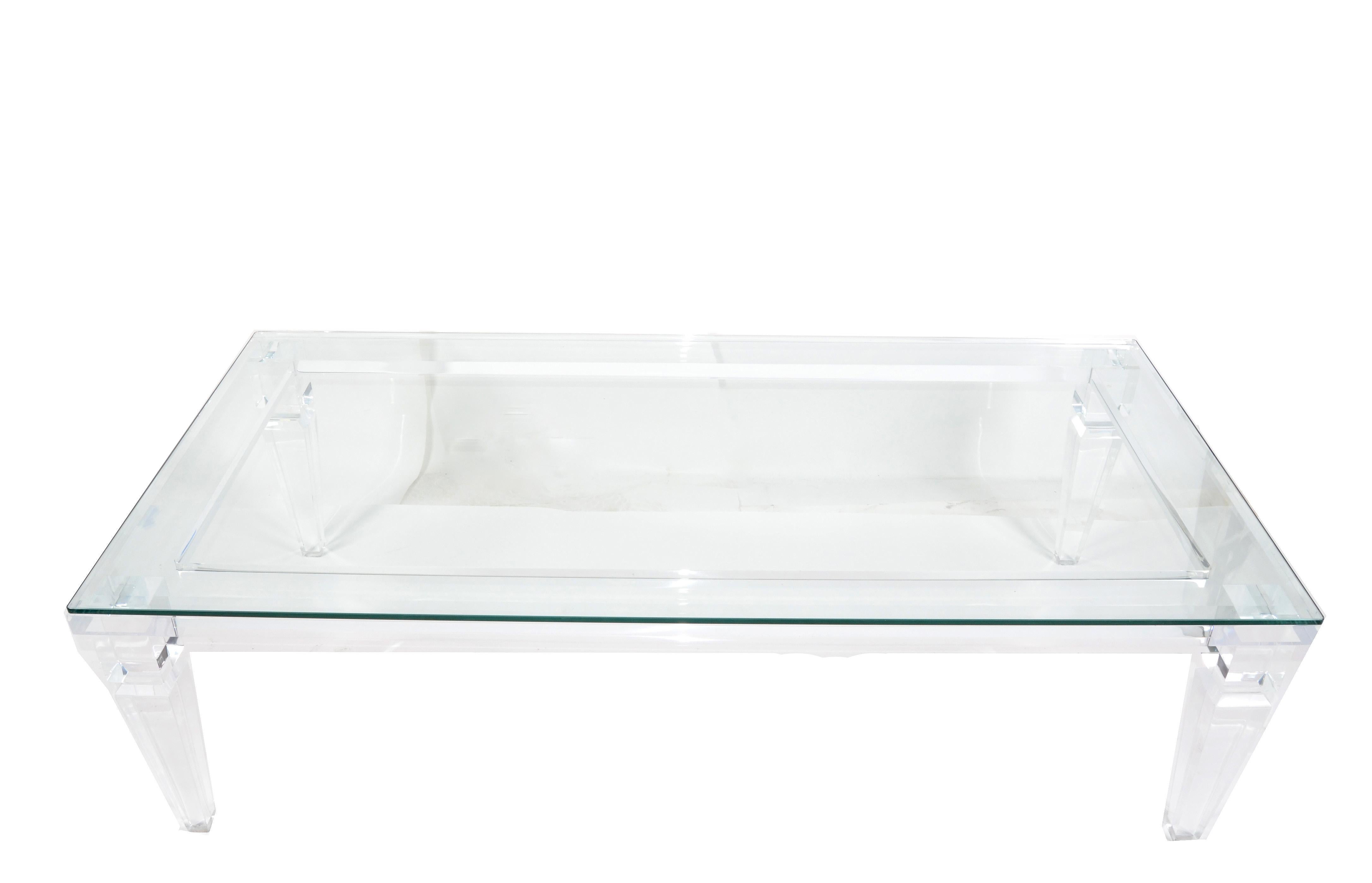 1970s rectangular Lucite and beveled glass coffee table with tapered Lucite legs by Charles Hollis Jones.
Lucite frame constructed with sturdy and durable carved Lucite Legs.
Features a 3/8 inches thick clear glass top which rests on the frame.
 