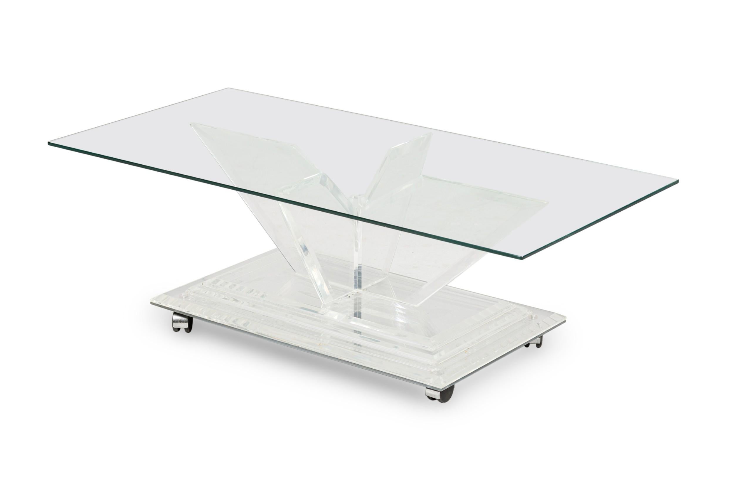 Mid-Century American lucite rectangular cocktail / coffee table frame features a mirrored top on a beveled, stepped lucite base supported on 4 V-shaped perpendicular flattened legs. (CHARLES HOLLIS JONES)

Some wear to finish
