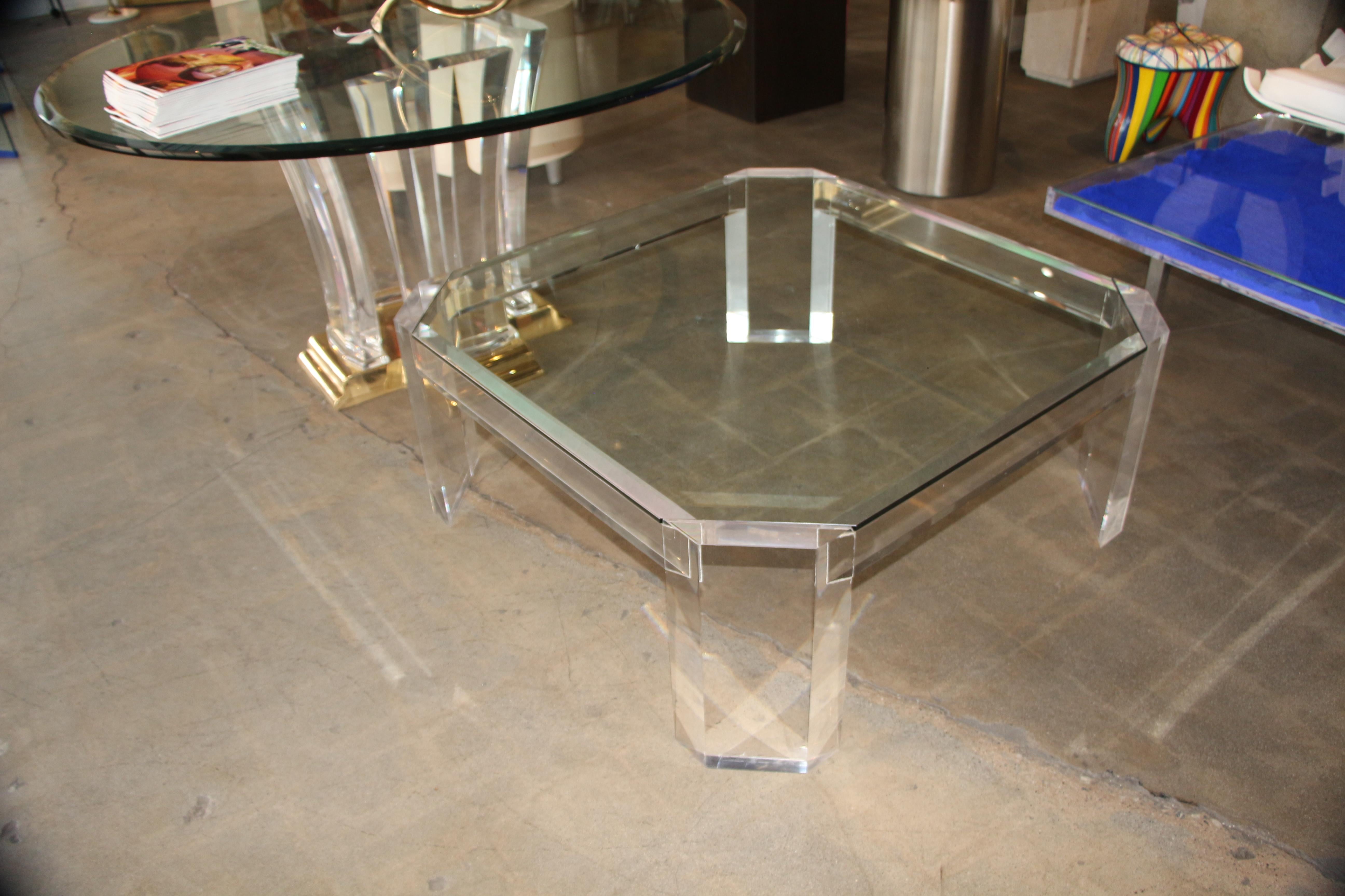 A vintage cut corner edge Coffee table with a Lucite base and a glass top. It dates from the 1970s according to Charles Hollis Jones. He said it was a model 505.  The glass may be new, and it doesn't quite fit quite exactly on each corner, please
