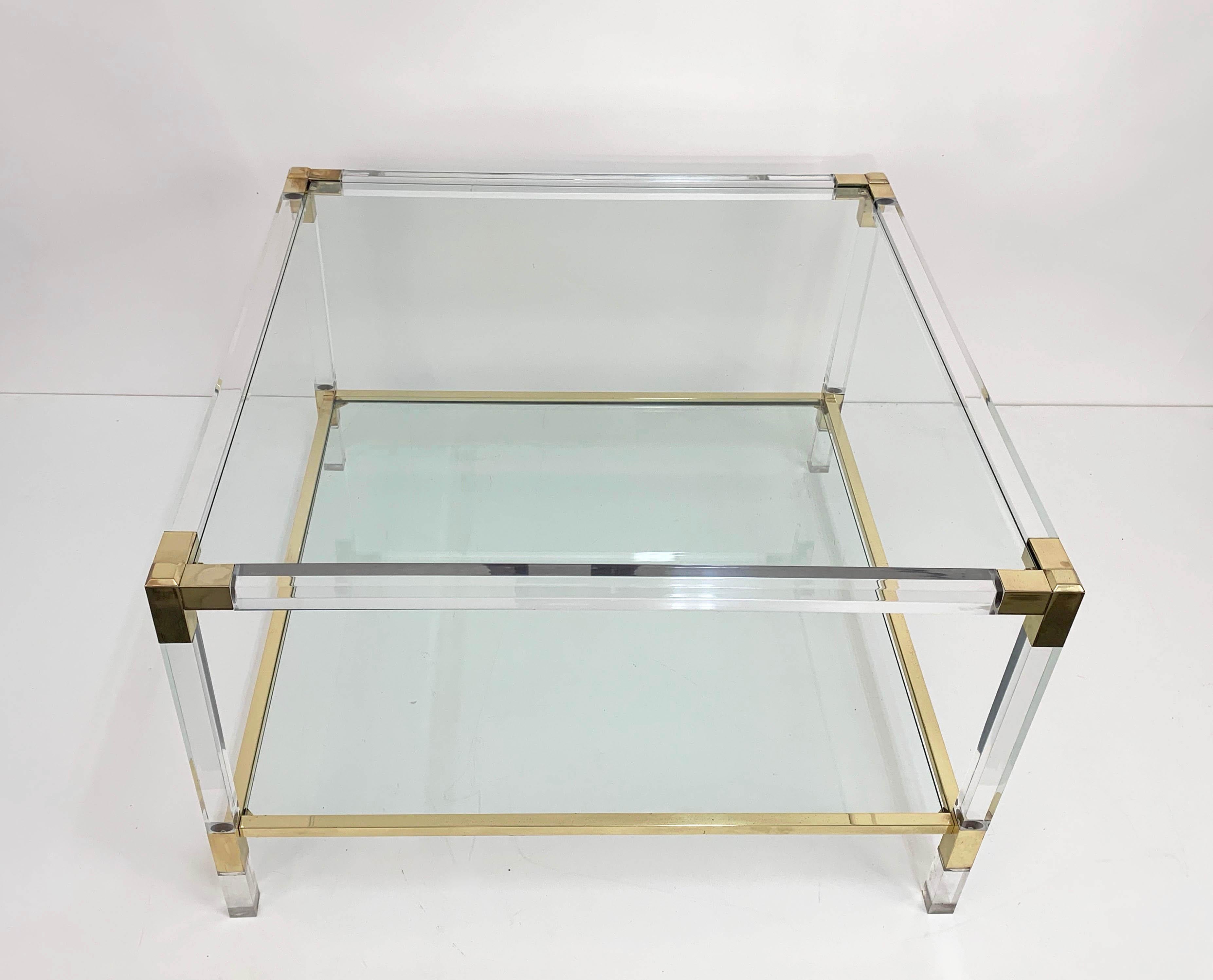 Wonderful Hollywood Regency coffee table or cocktail table with two glass shelves. This amazing item is attributed to Charles Hollis Jones and was produced in Italy during the 1970s.

This piece is amazing because of its Hollywood regency lines