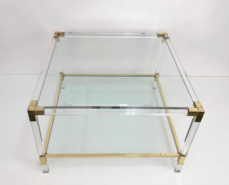 Wonderful Hollywood Regency coffee table or cocktail table with two glass shelves. This amazing item is attributed to Charles Hollis Jones and was produced in Italy during the 1970s.

This piece is amazing because of its Hollywood regency lines