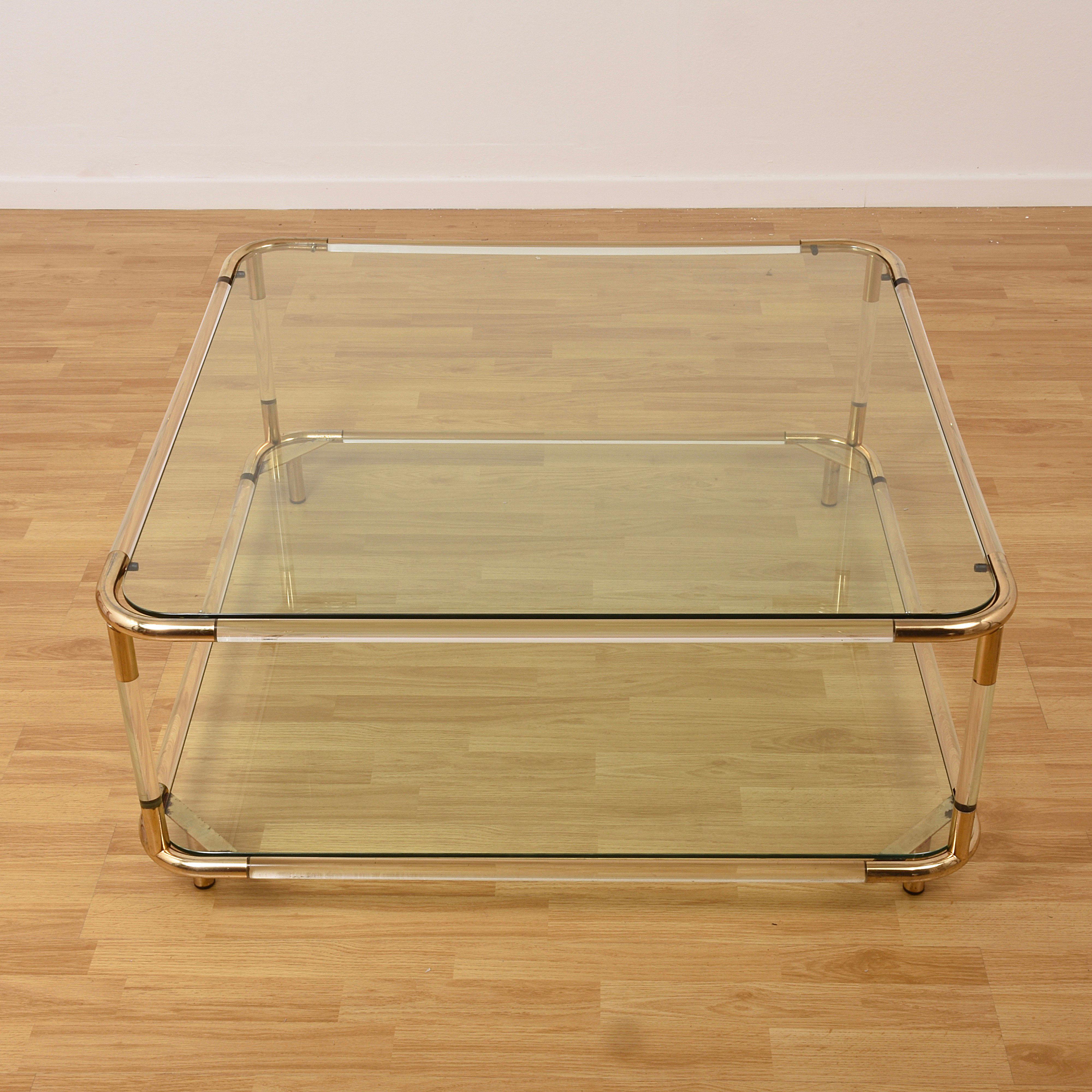 Two-storey coffee table in plexiglass and polished brass. In the style of Charles Hollis Jones
Dimensions: 39.37 x 39.37 x 17.71.