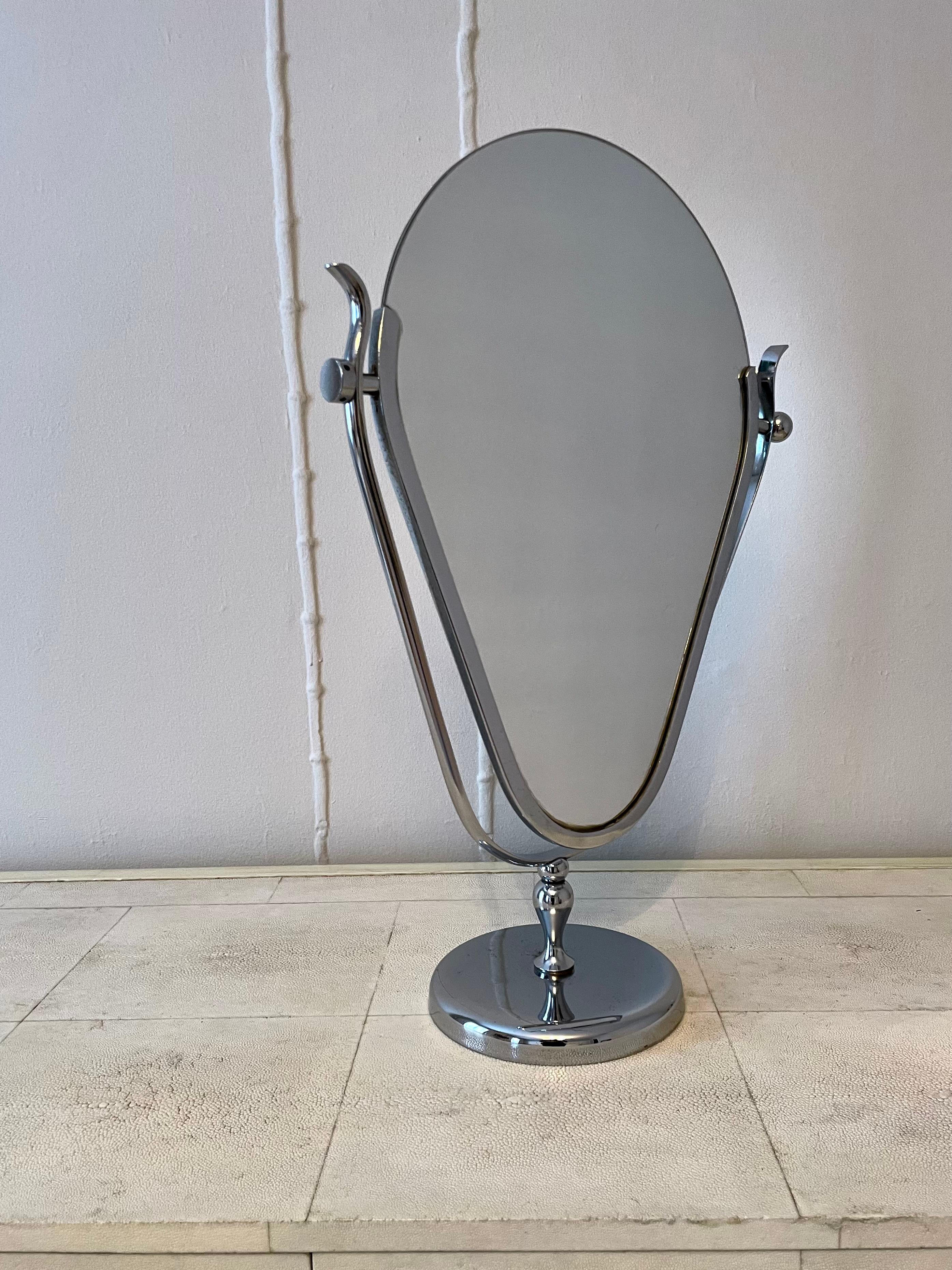 Table mirror in the style of Charles Hollis Jones perfect for vanity. One side features a ball attachment while the other is a disk, a unique touch that gives a slight wabi-sabi value to the piece. 


 Some insignificant loss on the base, see