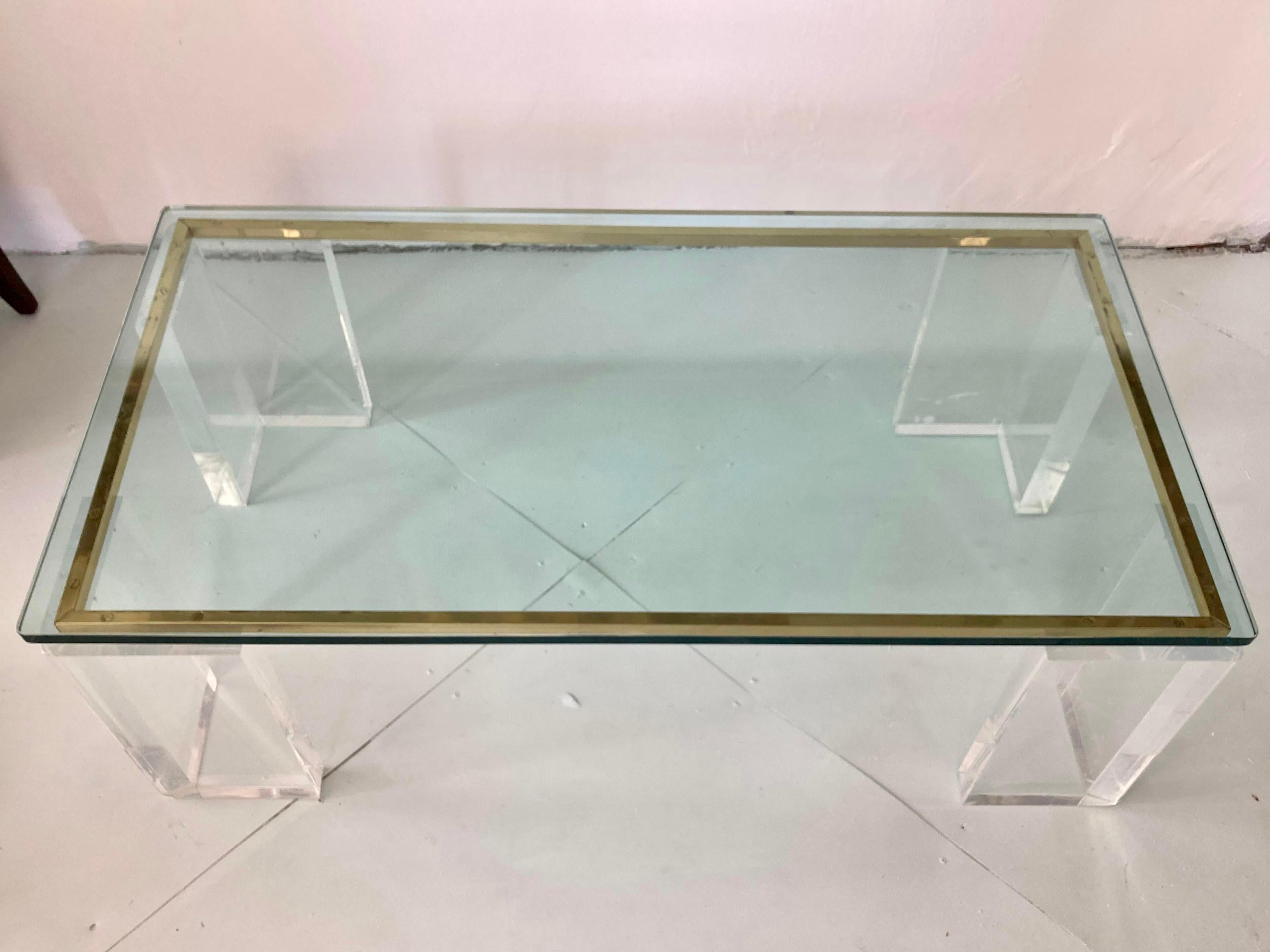 Fabulous modern Charles Hollis Jones lucite rectangular coffee table. Wonderful thick lucite with Brass metal details. Great addition to your modern inspired interiors. This item is not marked or signed by the designer or original manufacturer.