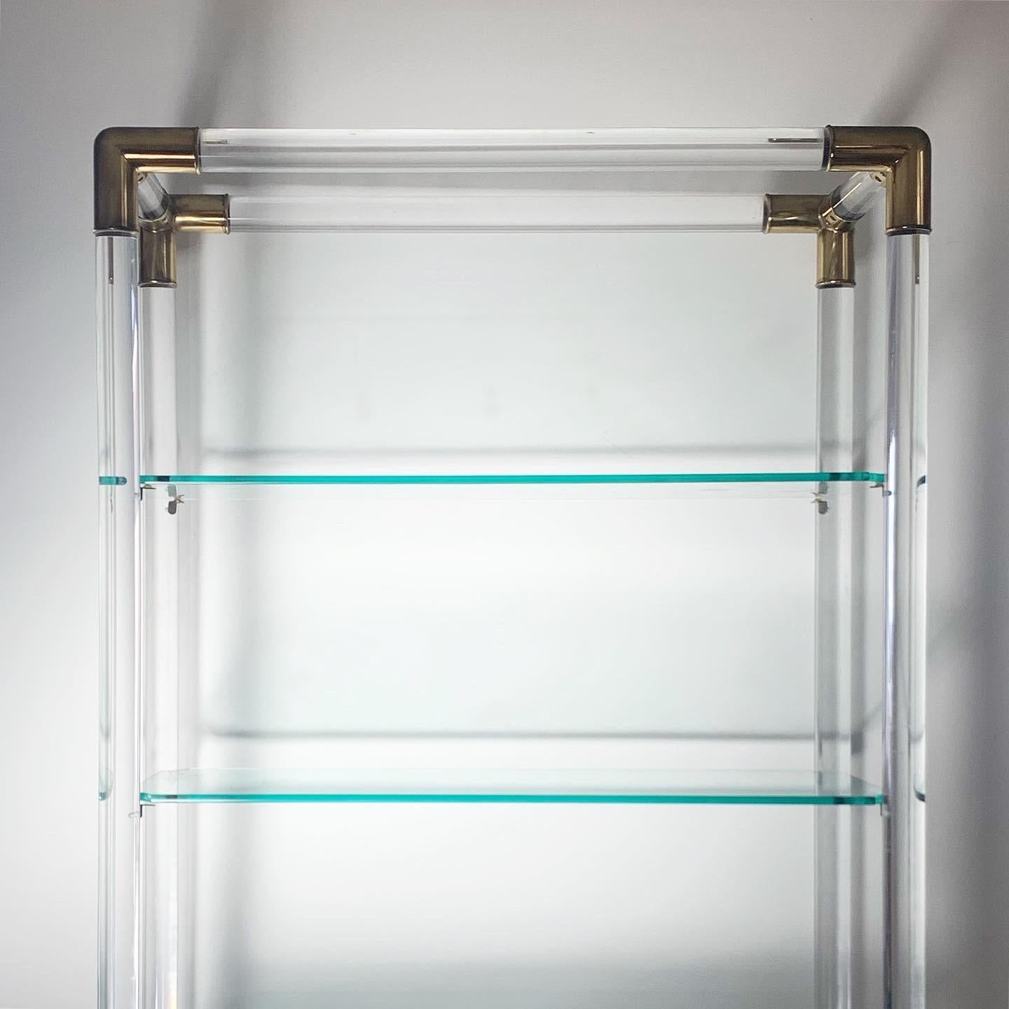 Charles Hollis Jones style lucite and brass mid century bookshelf / étagère with glass shelves. Circa mid 1960s. Wear consistent with age and use, but overall great condition. Shelves are removable for storage and transport. Quite heavy. 