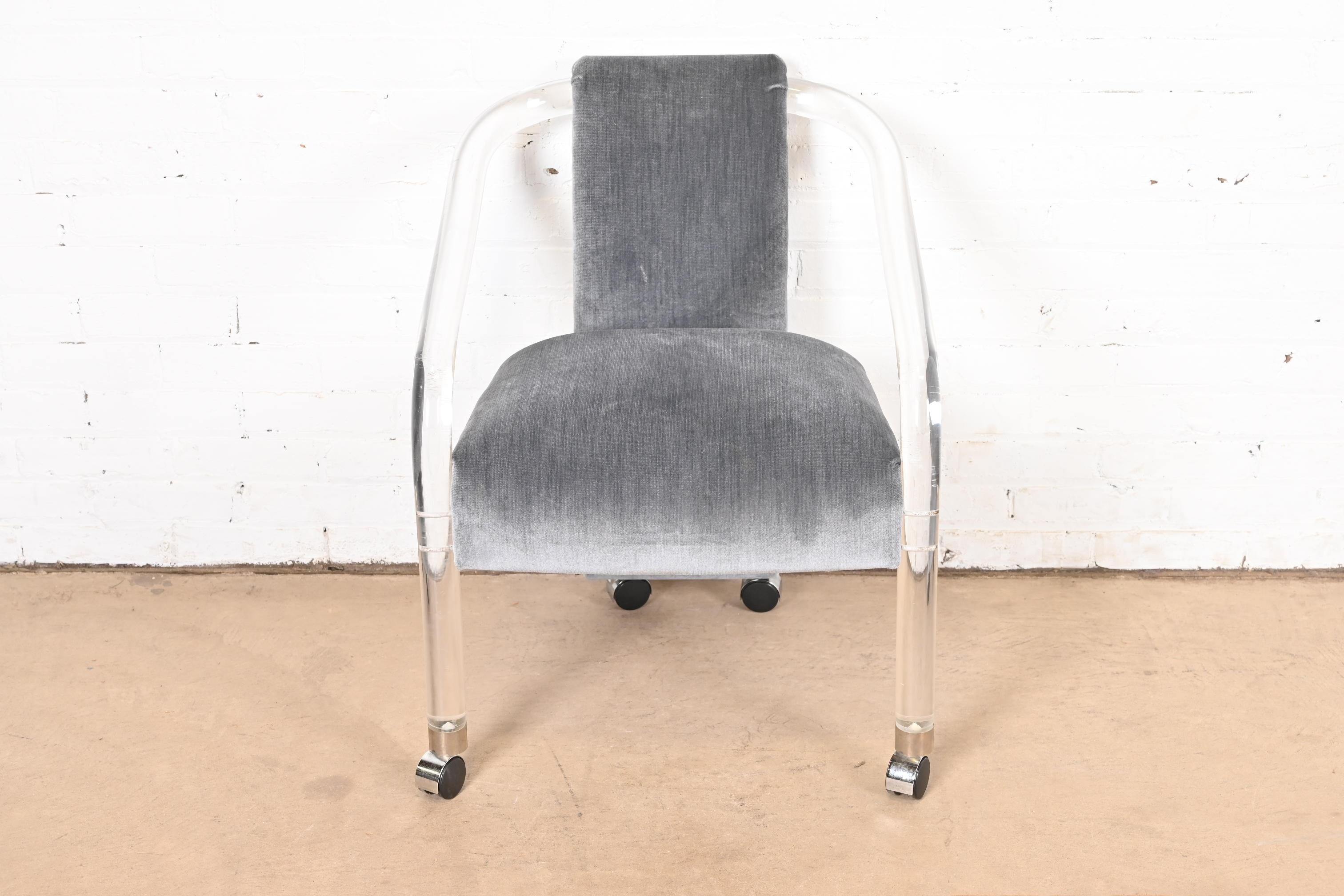 A gorgeous Modern Art Deco or Mid-Century Modern lucite armchair, club chair, or lounge chair

In the manner of Charles Hollis Jones

By Hill Manufacturing Co. (label present)

USA, Circa 1970s

Sculptural lucite frames on casters, with gray velour