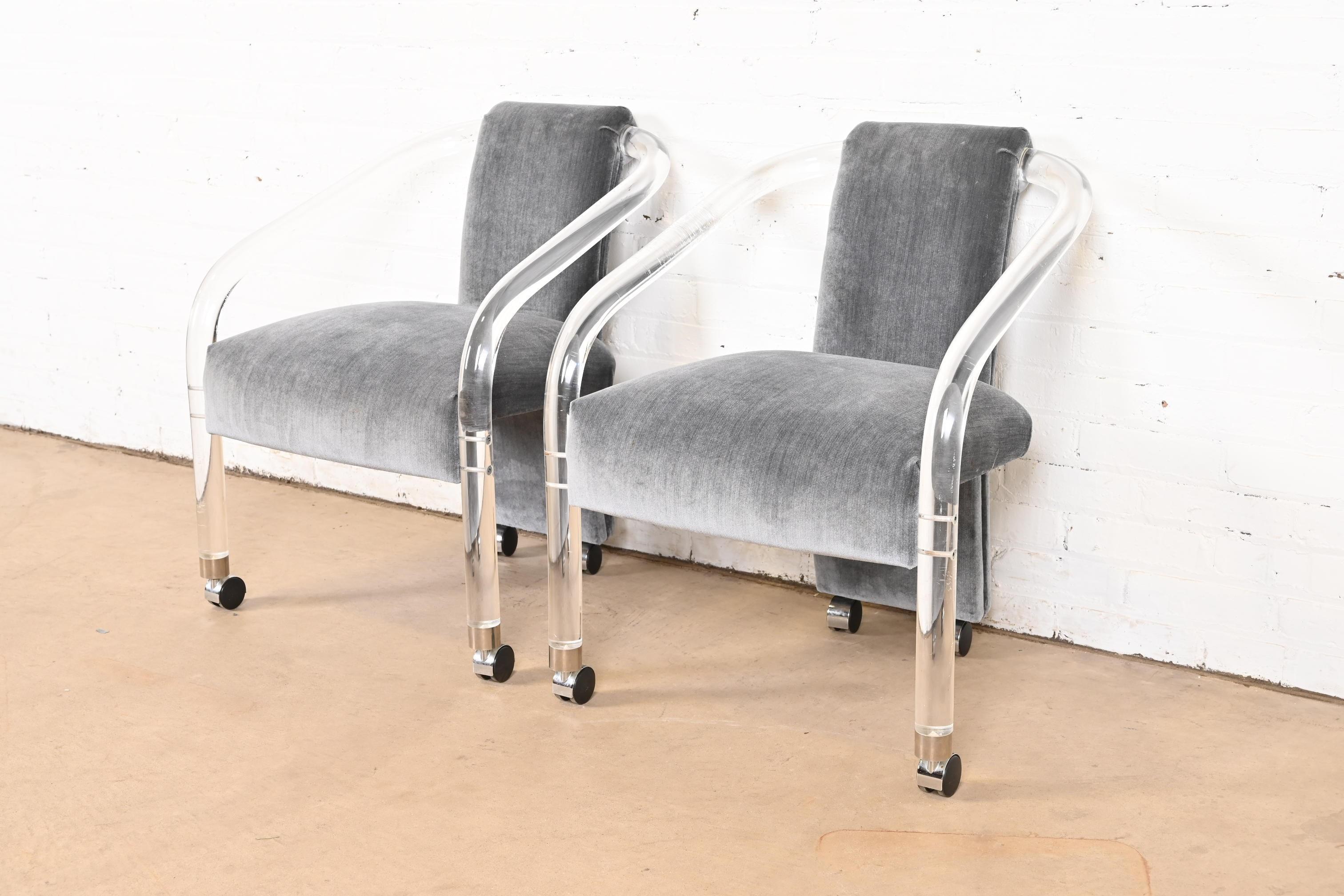 A gorgeous pair of Modern Art Deco or Mid-Century Modern lucite armchairs, club chairs, or lounge chairs

In the manner of Charles Hollis Jones

By Hill Manufacturing Co. (label present)

USA, Circa 1970s

Sculptural lucite frames on casters, with