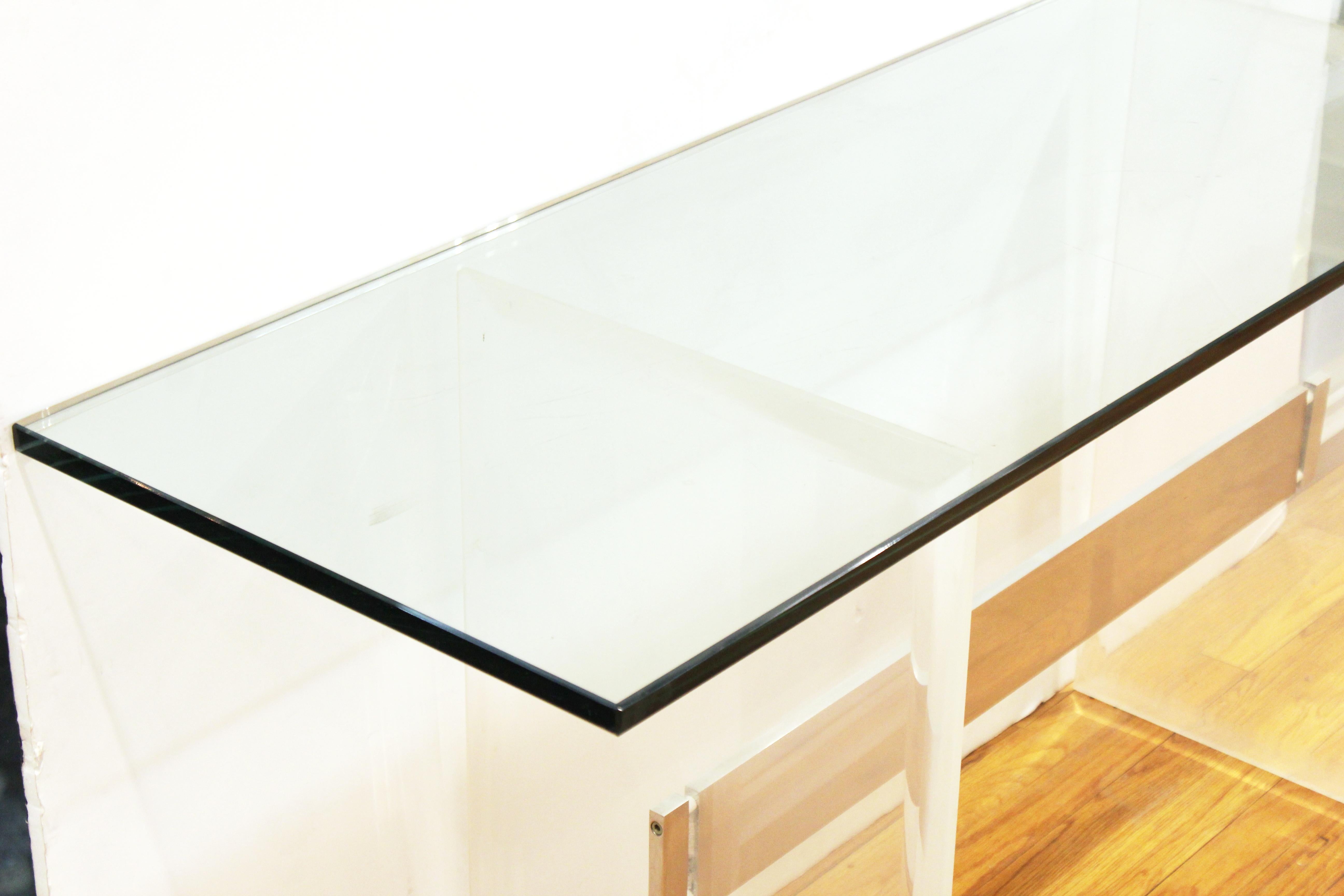 Modern console table in the style of Charles Hollis Jones. The piece has a glass top and Lucite structure with metal beam. In great vintage condition with age-appropriate wear and use, with scratches in the glass top.