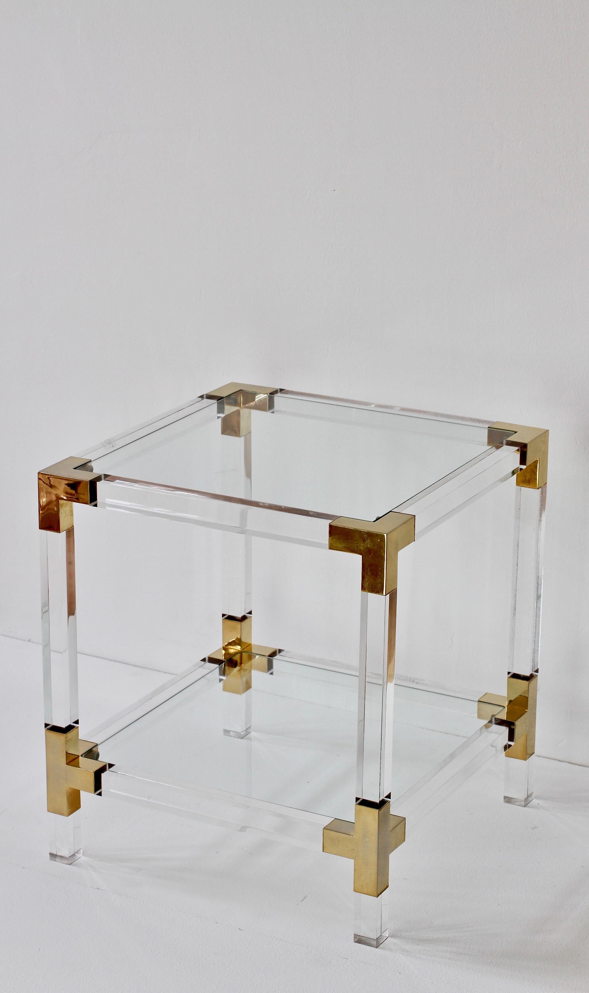 Charles Hollis Jones 'Metric' style square two-tiered (double shelf) side or end table made of Lucite / Acrylic with glass tabletop and brass corners and trim. Perfect for the modern Hollywood Regency style.
 

