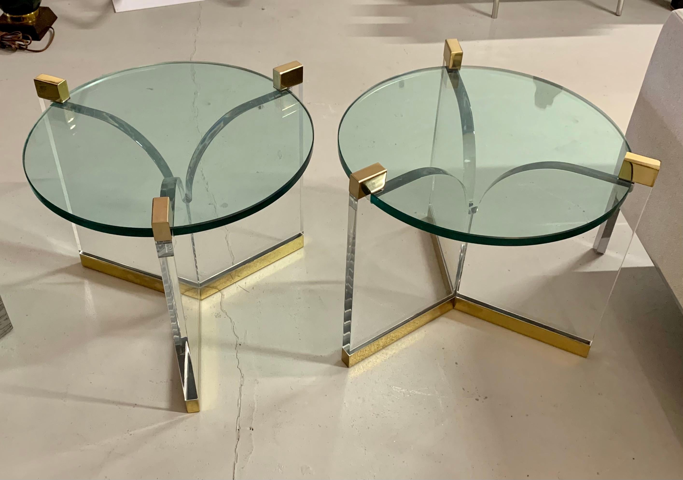 A pair of Charles Hollis Jones trefoil tables in brass, Lucite and glass. These are vintage tables, not new production. The glass top diameter alone is 20 inches and measuring taking into account the ends it is 22 1/2 inches in diameter. The brass