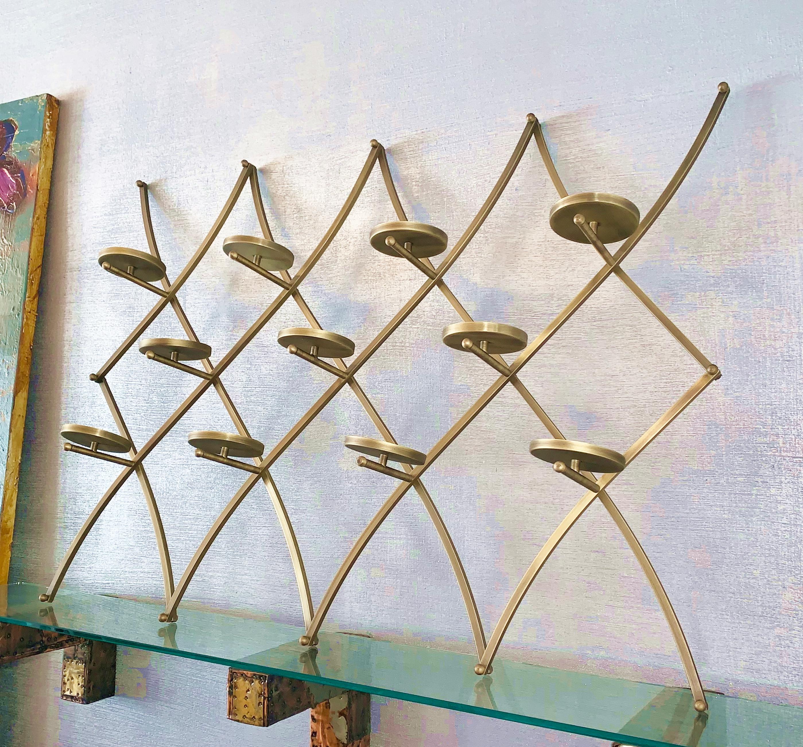 Charles Hollis Jones “Treillage” wall candleholder/display in solid brass with an antique finish. 
Measures: 
49” wide x 36” high x 8” deep, each candleholder or vase holder is 5” diameter.