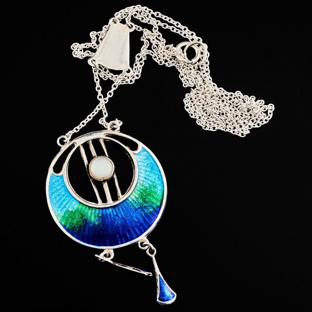 Heading : Chester Horner Arts and Crafts silver and enamel pendant
Date : Hallmarked in Chester in 1909 for Charles Honer
Period : George V
Origin : Chester, England
Decoration : Circular pendant with scarab wing enamel to the lower half and central