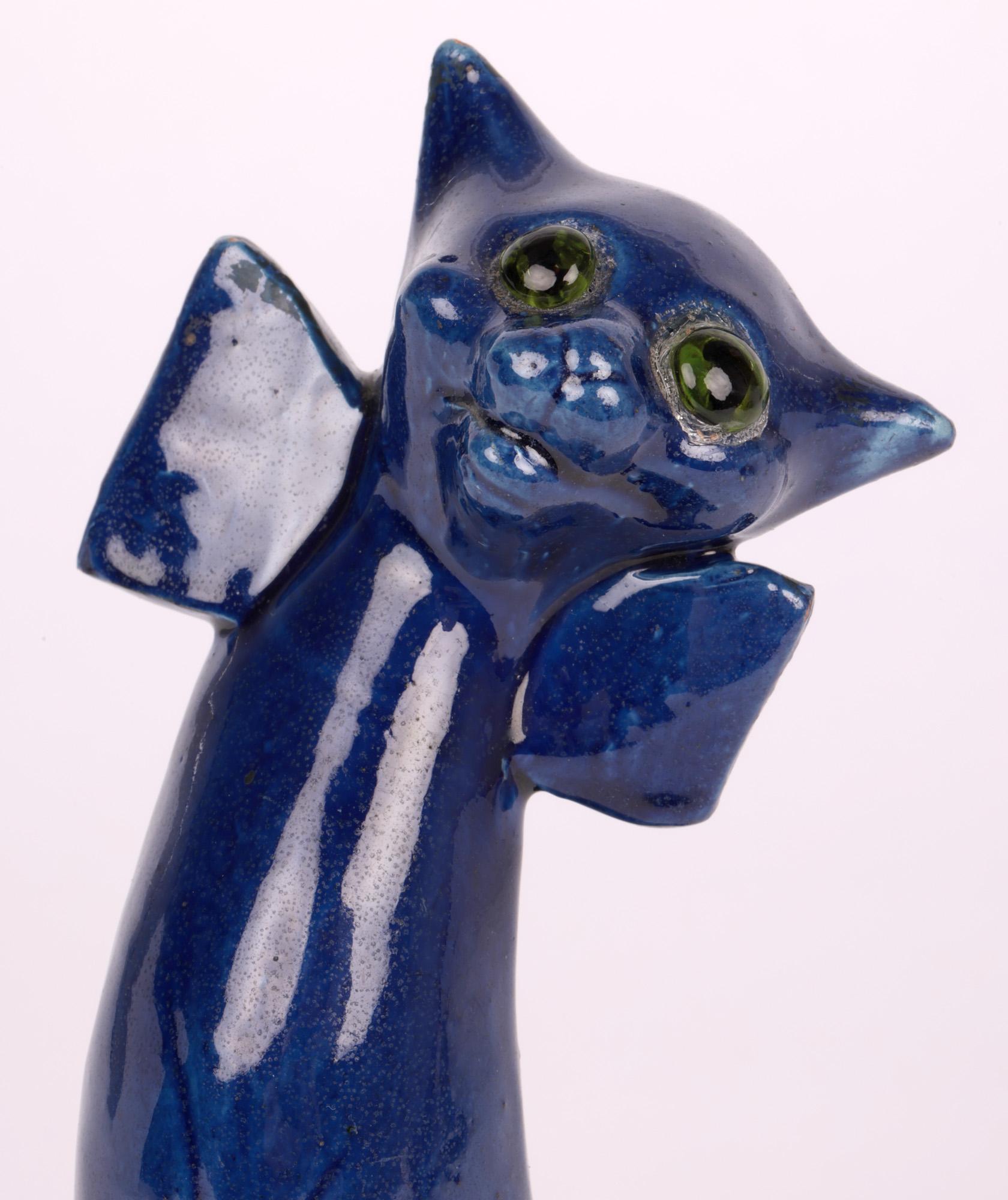 An unusual large art pottery figure of a grotesque smiling cat with glass eyes from an original design by Blanche Vulliamy made by Charles Hubert Brannam and dating from around 1905.
The Brannam pottery was started by Thomas Brannam in Barnstaple,