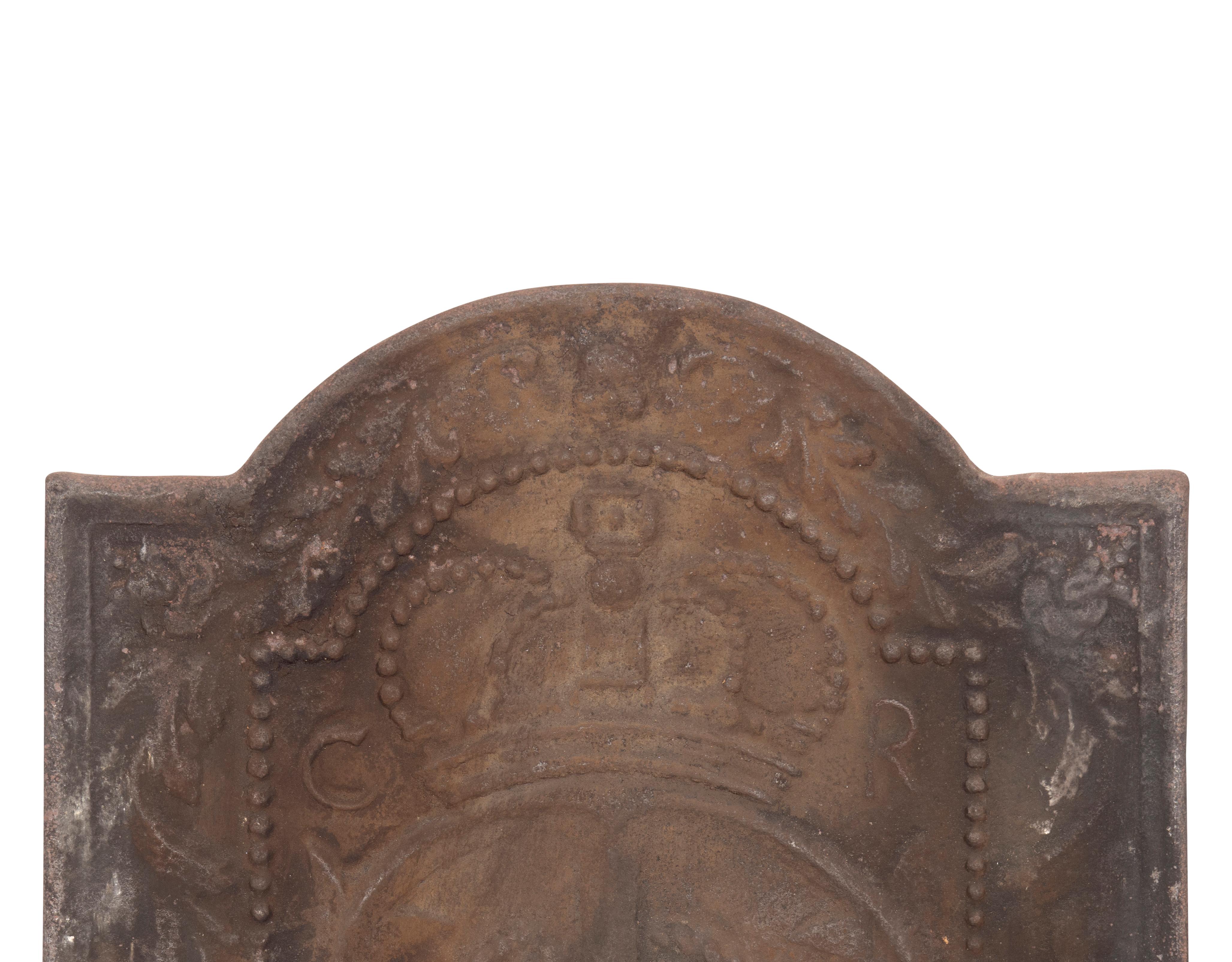 Arched top with cast royal crown and anchor with rope and initials C for Charles and R for rex or king.