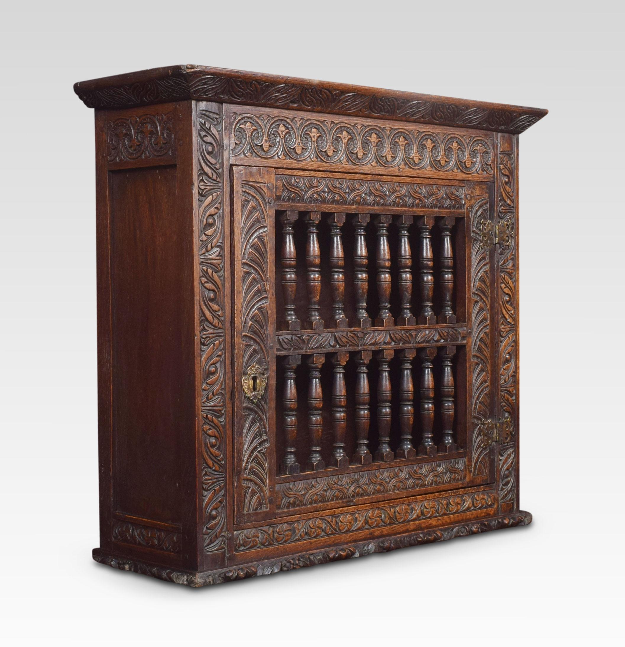 Charles II joined and boarded oak mural ventilated livery cupboard, the single door with two rows of eight baluster-turned spindles within carved molded rails, enclosing a shelved interior.
Dimensions:
Height 27 inches
Width 29.5 inches
Depth 10
