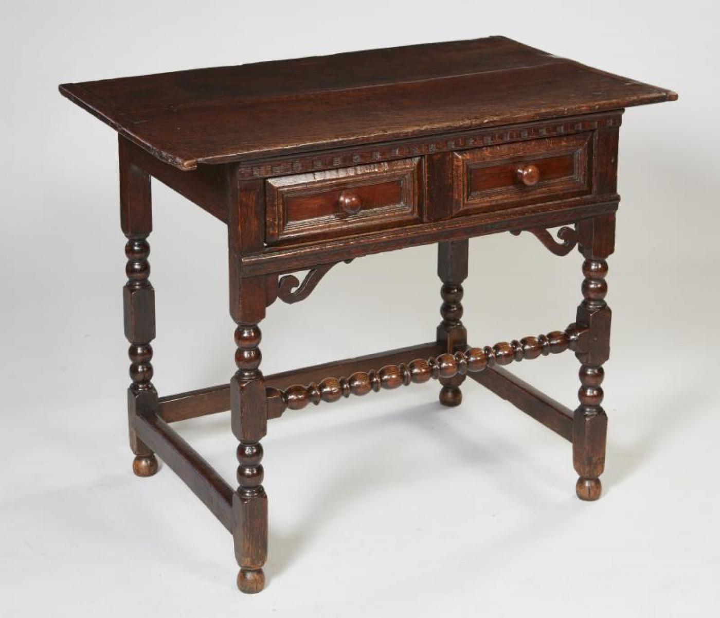 Very fine Charles II period English oak side table, the two plank top with breadboard ends over dentil molded frieze over single drawer with geometric molding and later turned yewwood pulls, over cross hatched support with pierced spandel brackets,