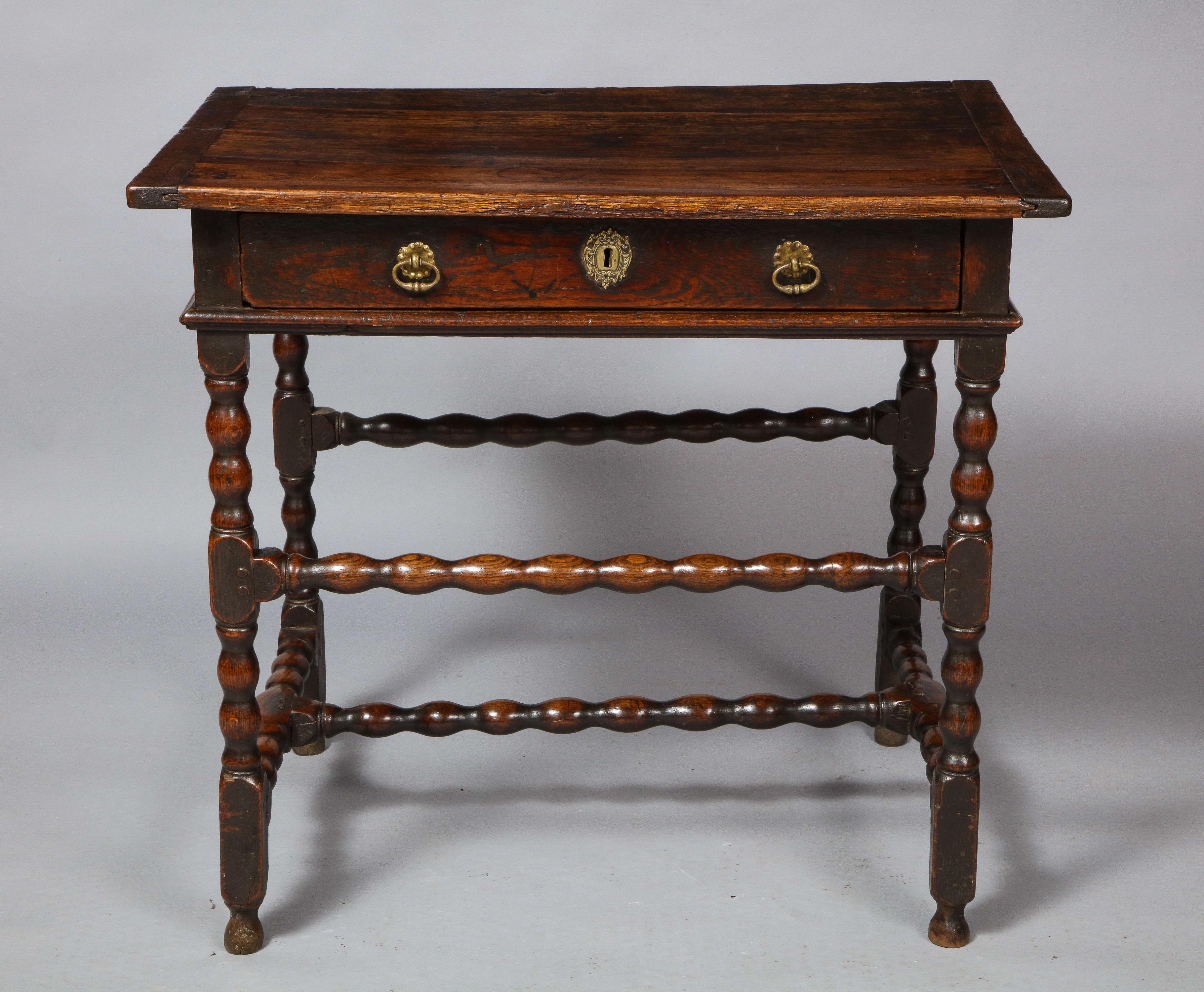 Fine Charles II period oak side table, the top with breadboard ends over single drawer over molded apron, the sausage turned legs with desirable high and low cross stretchers and standing on original turned feet, the whole possessing good rich color