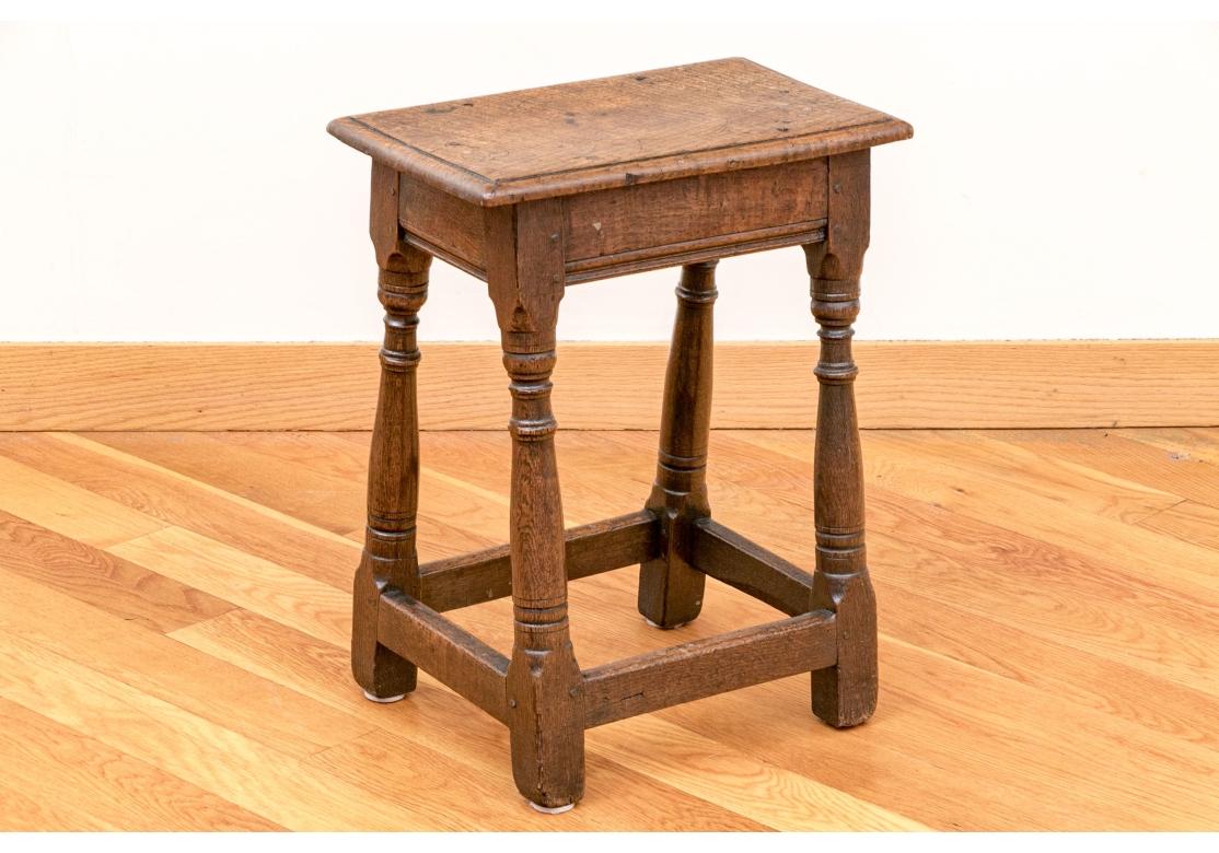Sturdy Charles II oak rectangular stool with incised edge, peg construction, baluster form turned legs conjoined with a box stretcher. Initialed 