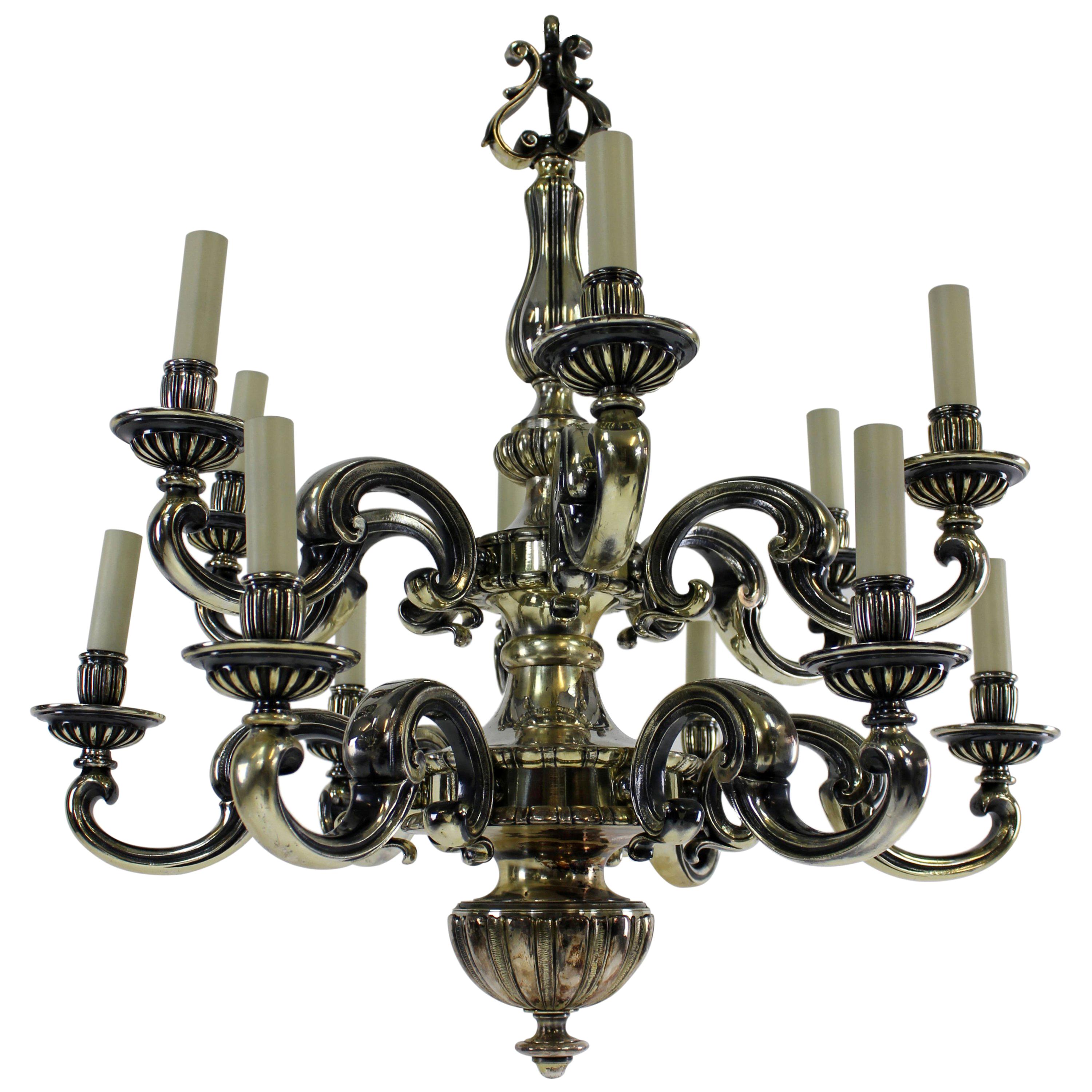 An English silver plated bronze chandelier of fine quality in the Charles II style comprising two tiers and twelve lights in total.

Newly electrified.