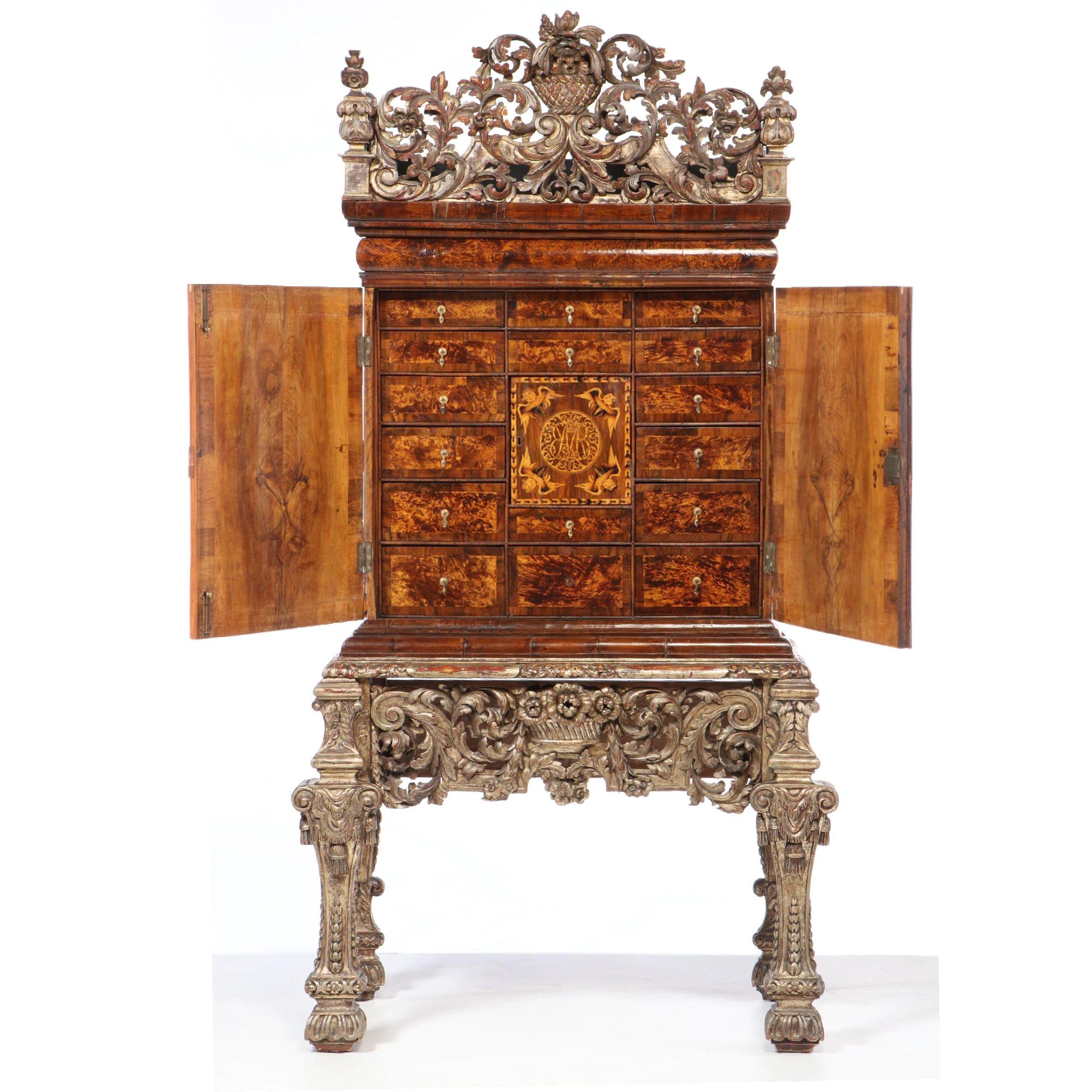 Charles II walnut and mulberry marquetry cabinet on giltwood stand, c. 1650-1670. Giltwood cresting and stand appear to be from a few decades later. 
 The form of furniture now described as a cabinet developed across Spain and France in the 16th