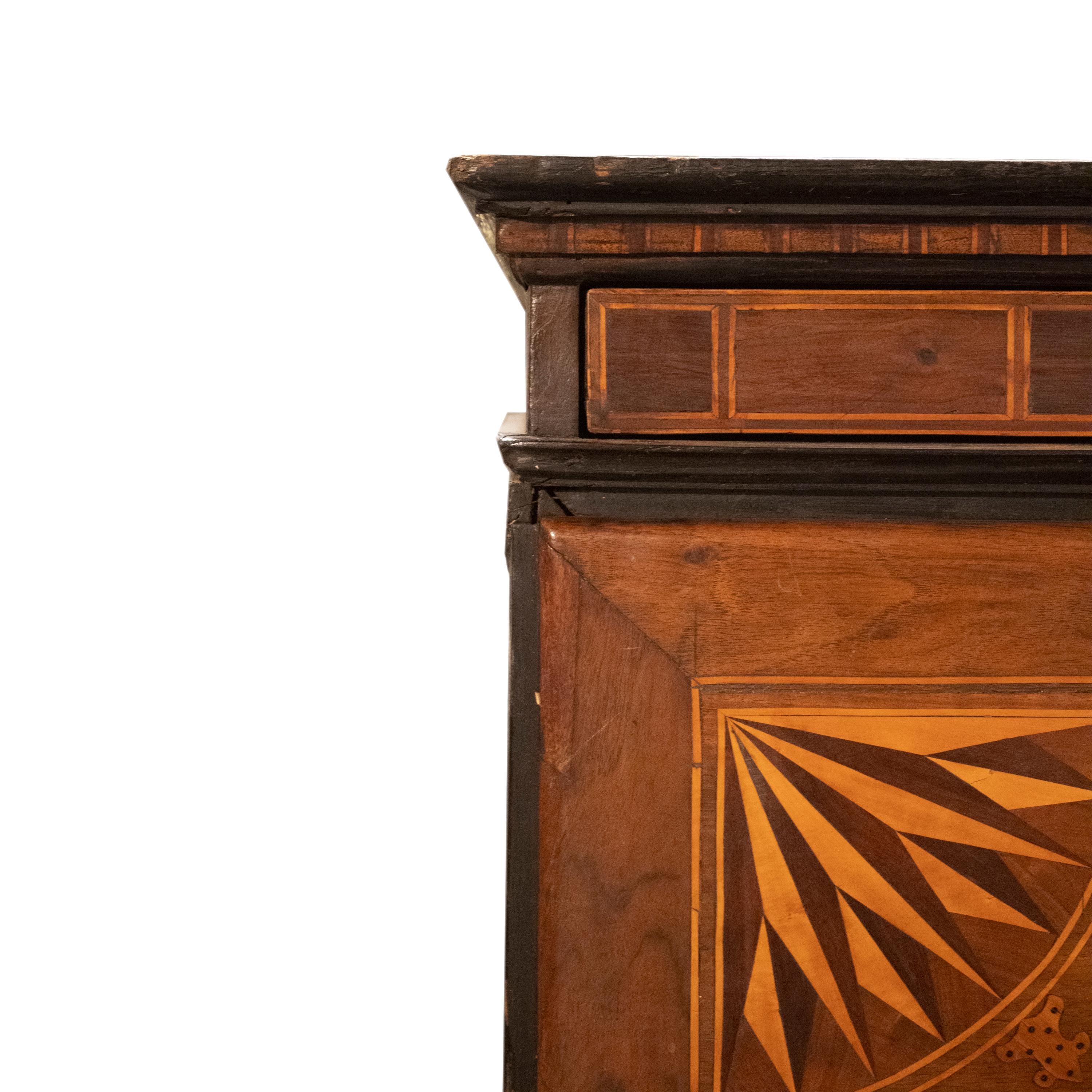Un rarissimo armadio o secretaire con cassettiera in legno massiccio di noce, intarsiato con legno di frutta in stile neoclassico. Il coperchio centrale può essere ripiegato, trasformandosi in una superficie di scrittura, rivelando cassetti interni