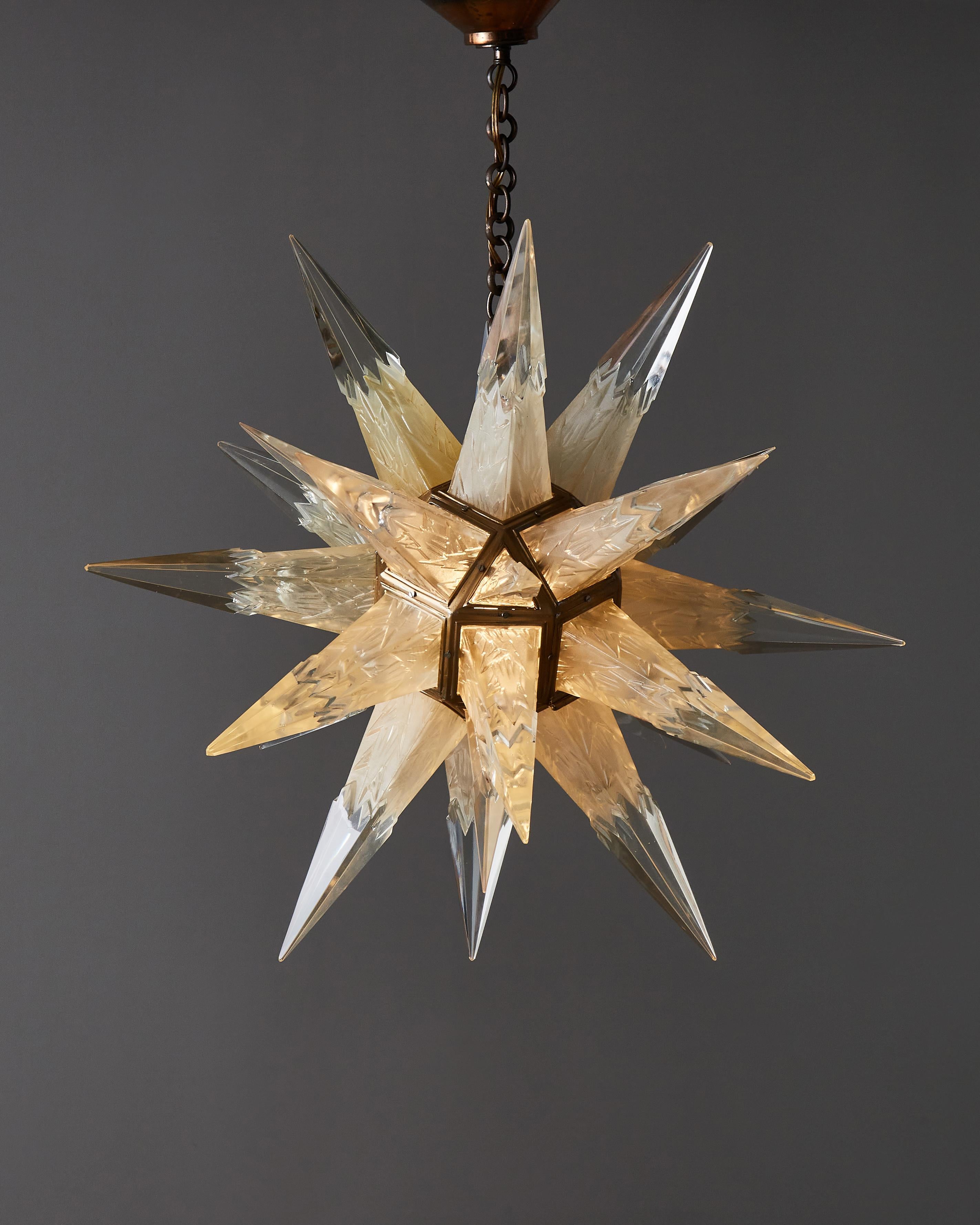 Beautiful chandelier designed in 1931 by the Charles J. Weinstein company in New York in 1931. Brass structure with clear and frosted moulded glass spikes.

- Anne Bony, 