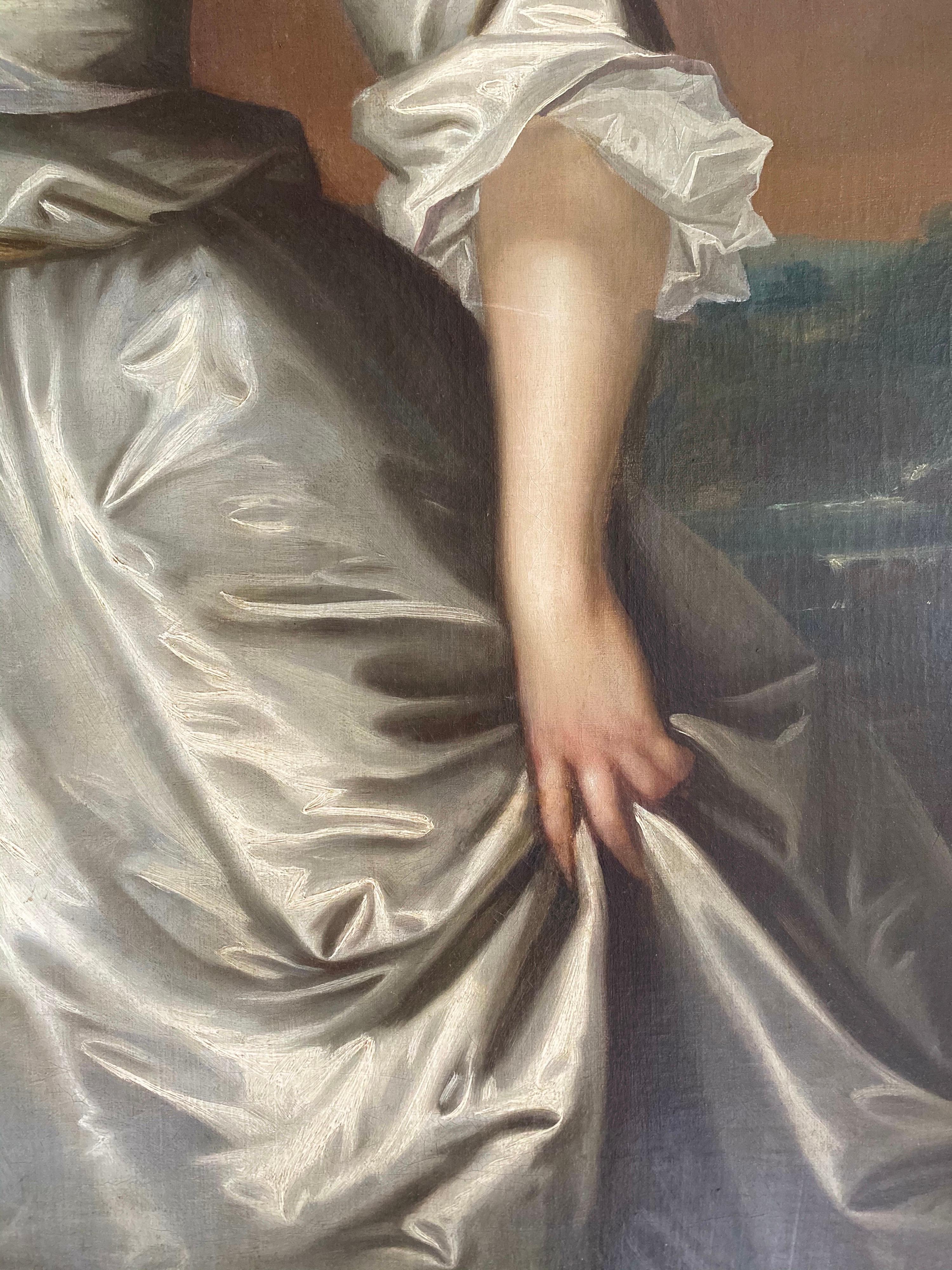 Porträt von Henrietta Pelham-Holles (geb. Godolphin) (1701-1776), Herzogin von Newcastle, in einer bewaldeten Landschaft mit einem Fluss in der Ferne stehend, dreiviertel lang, in einem elfenbeinfarbenen Seidenkleid, einen Blumenzweig in der Hand.