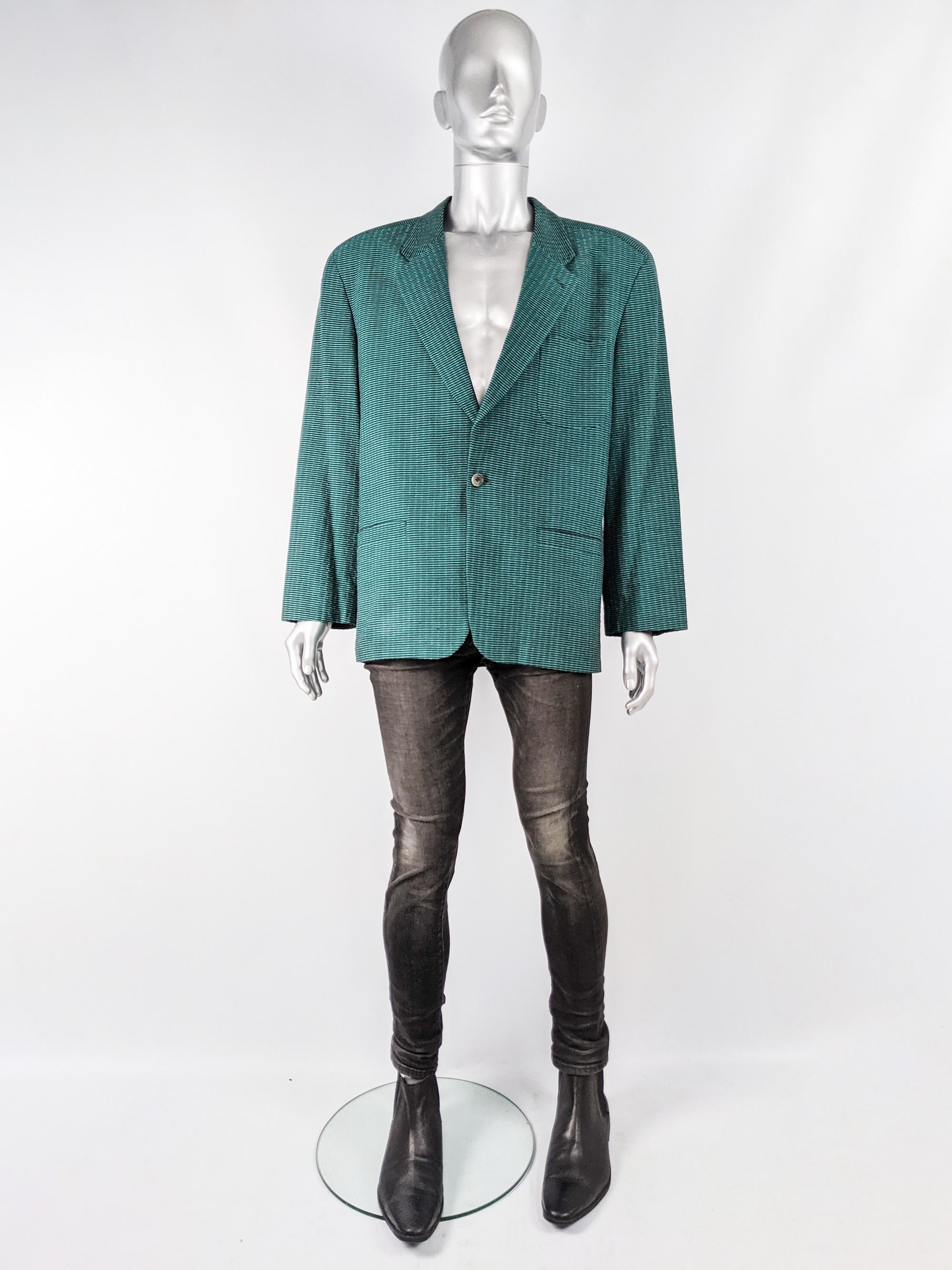 A vintage men's blazer jacket from the 80s by luxury French fashion designer Charles Jourdan.  It is made from a black and green seersucker textured fabric with notched lapels, shoulder pads and a single button fastening.
 
Size: Marked 52 which