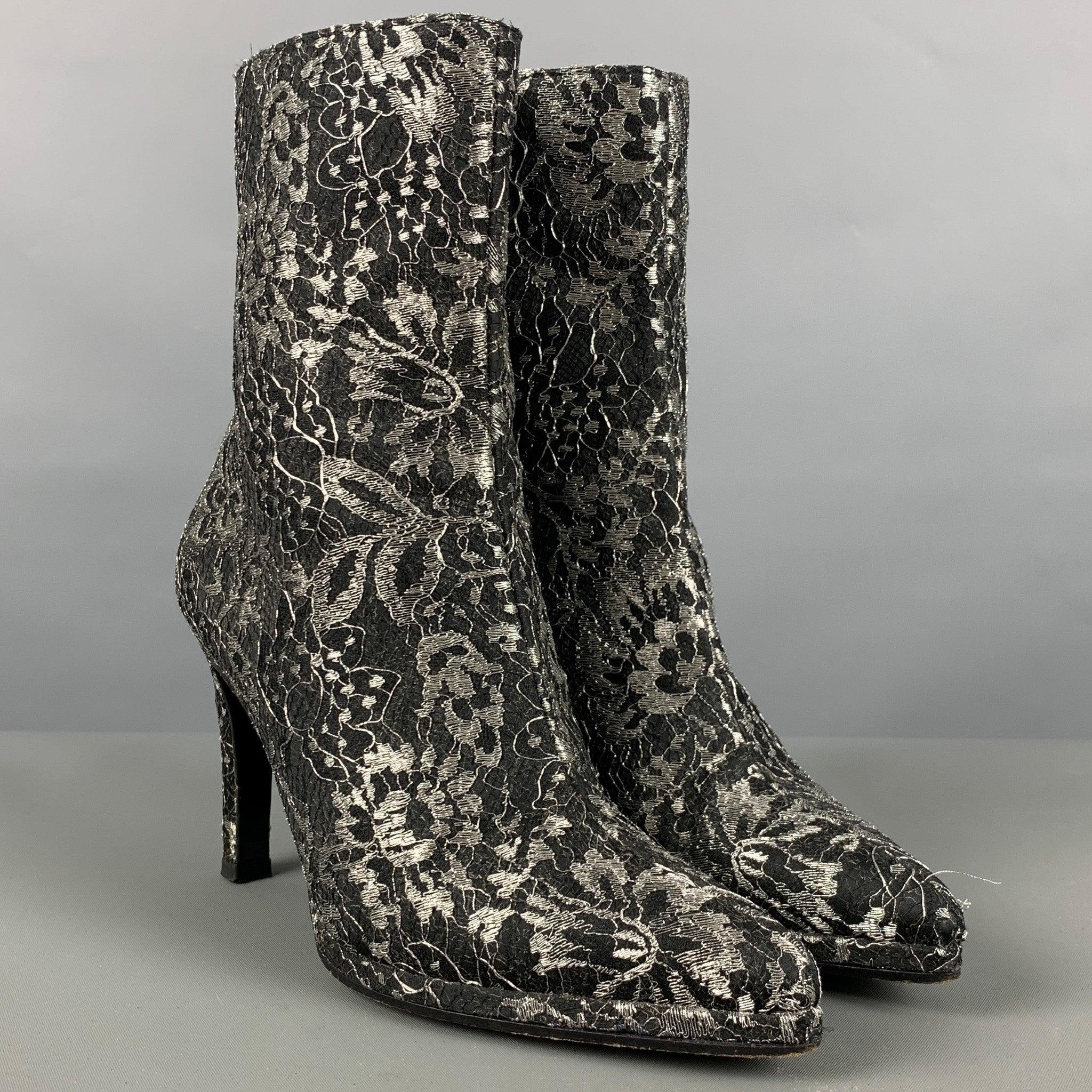 CHARLES JOURDAN ankle boots comes in a black and grey jacquard material featuring a side zipper and a steletto stiletto. Very Good Pre- Owned Conditions. Minor sign of wear. 

Marked:   COR 6435 5M 

Measurements: 
  Length: 8.25 inches Width: 2.75