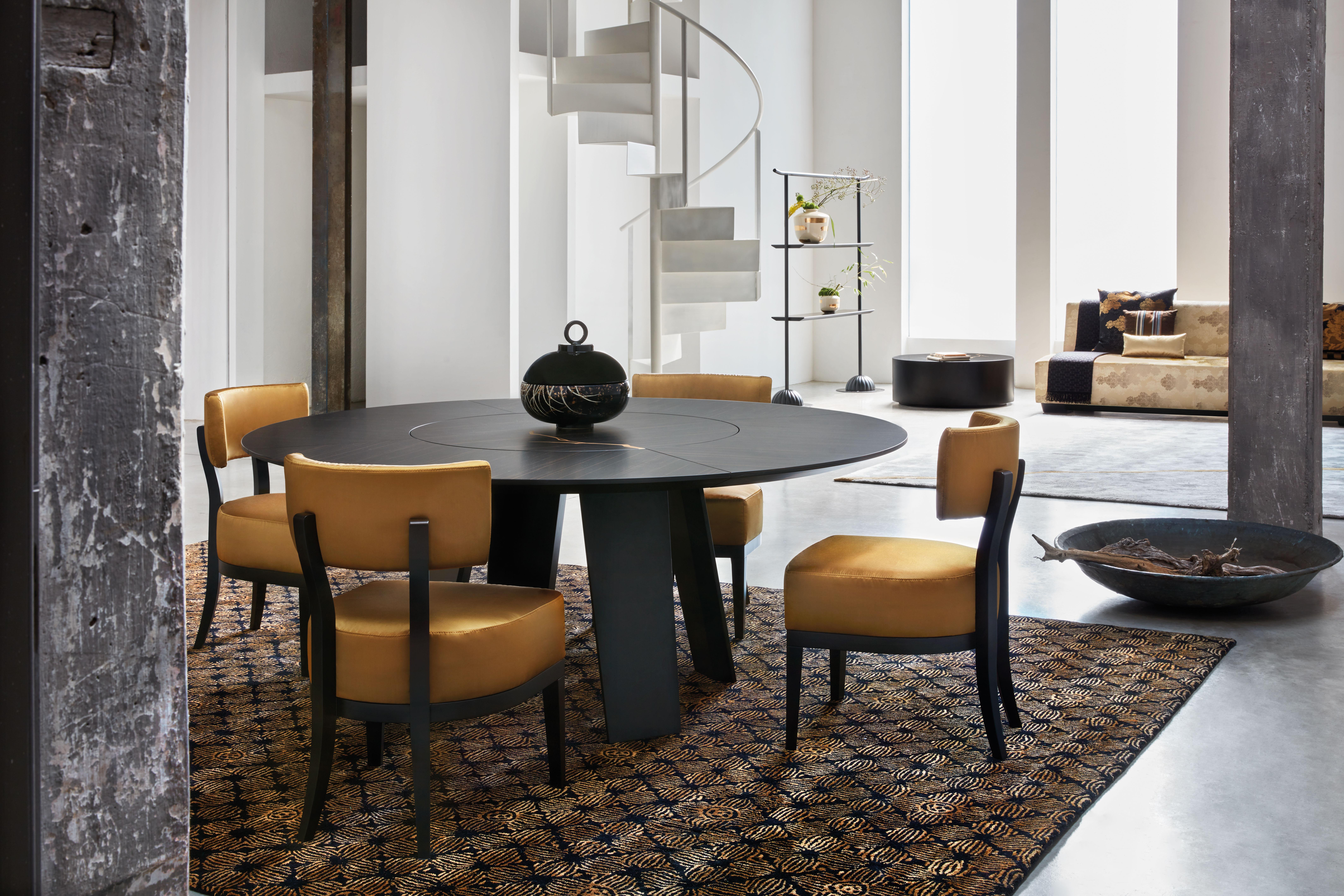 A contemporary rendition of a timeless classic, this exquisite chair adds an exceptional accent to a modern dining room when displayed in a series around one of K3's exclusive table designs. The matte-black lacquered plywood and steel structure is