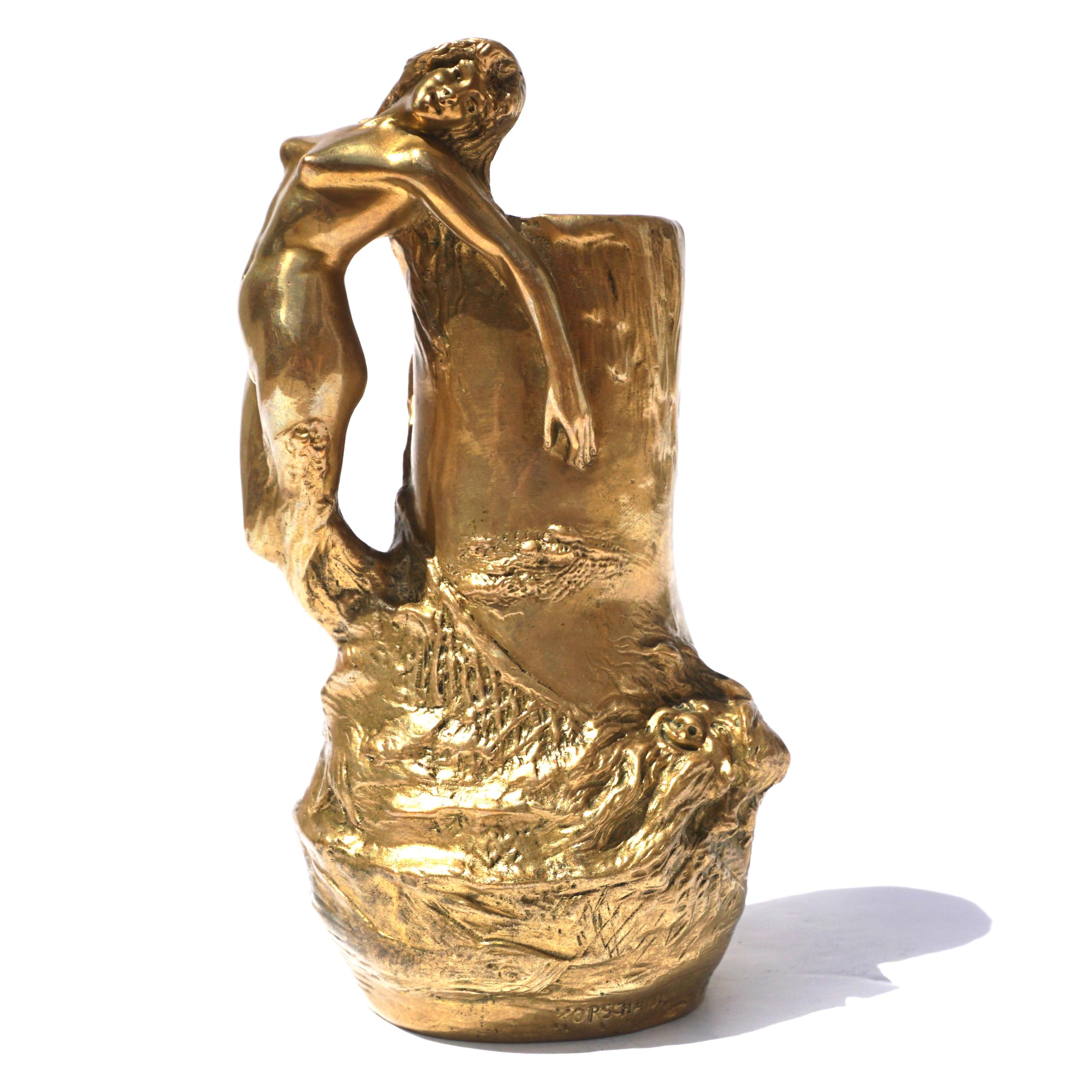 Charles Korschann Czechoslovakian 

Art Nouveau Gilt-Bronze Figural Bud Vase. Cast from a model by Charles (Karl) Korschann, circa 1899, of urn form, with a handle in the form of a siren caught in a net, engraved with a presentation ROGER 29