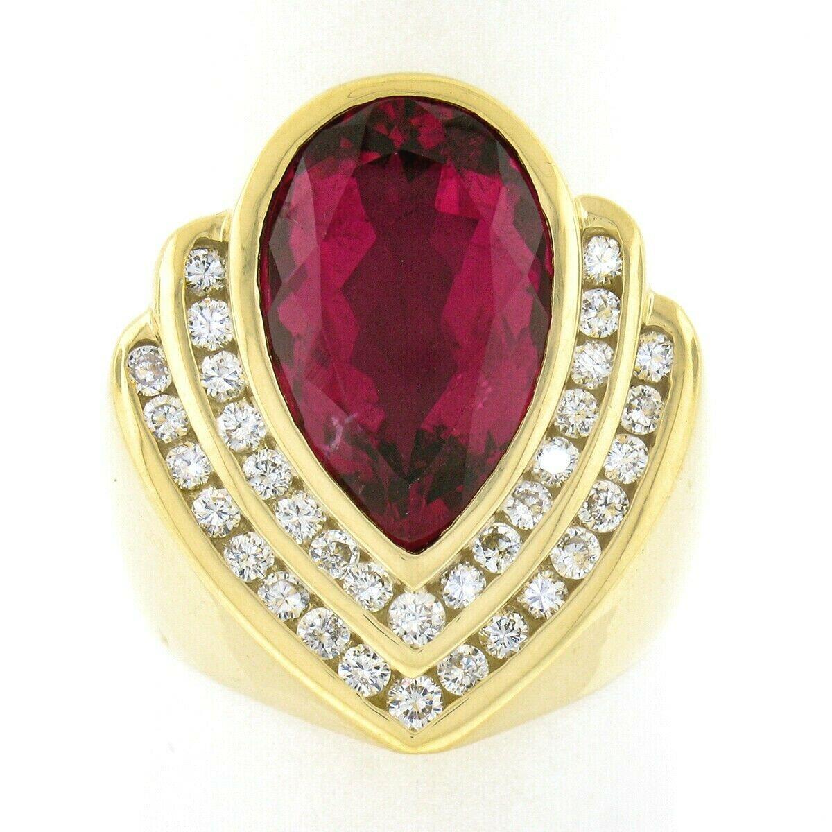 This magnificent vintage statement band ring was crafted from solid 18k yellow gold by Charles Krypell and features a large and absolutely stunning rubellite neatly bezel set at its top. The solitaire is pear brilliant cut and weighs approximately