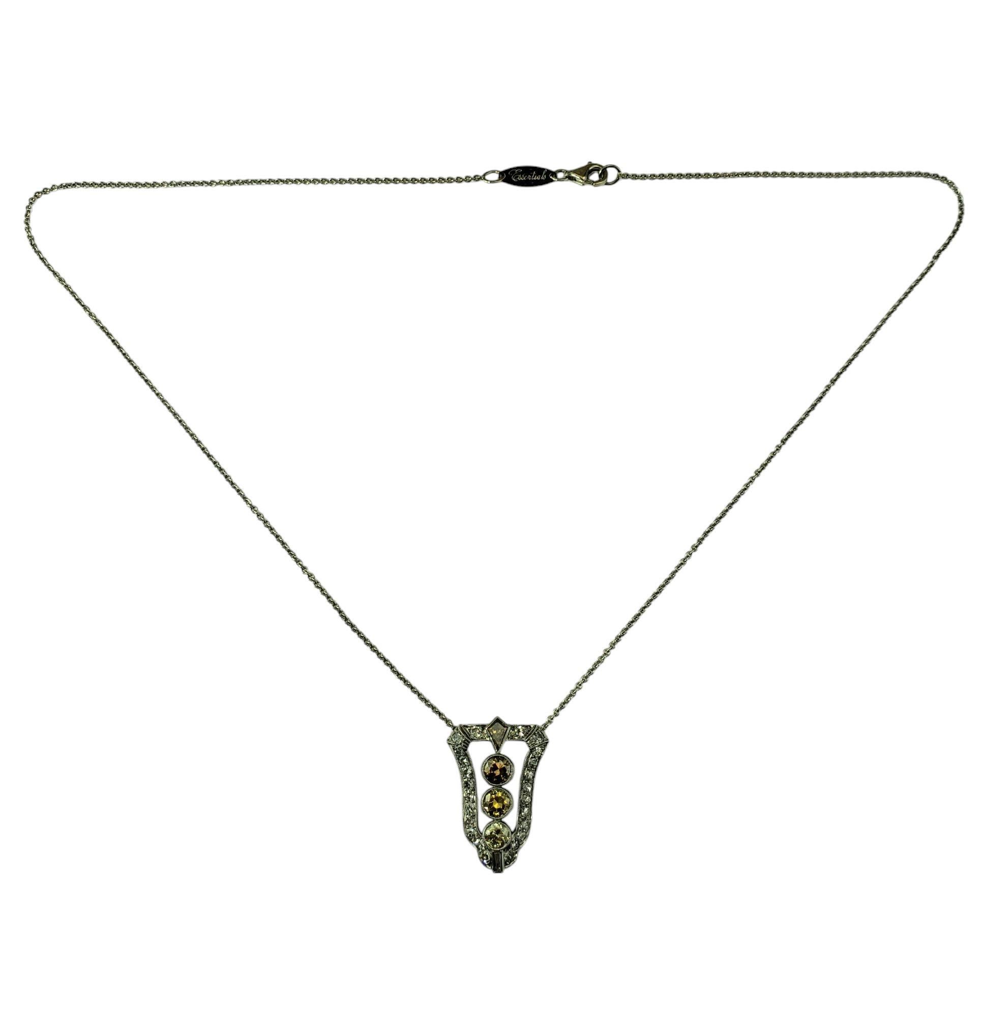 Charles Krypell 18K White Gold Brown and White Diamond Pendant Necklace JAGi Certified-

This stunning pendant necklace by Charles Krypell features three brown brilliant cut diamonds, one shield cut diamond, one baguette cut diamond and 24 round