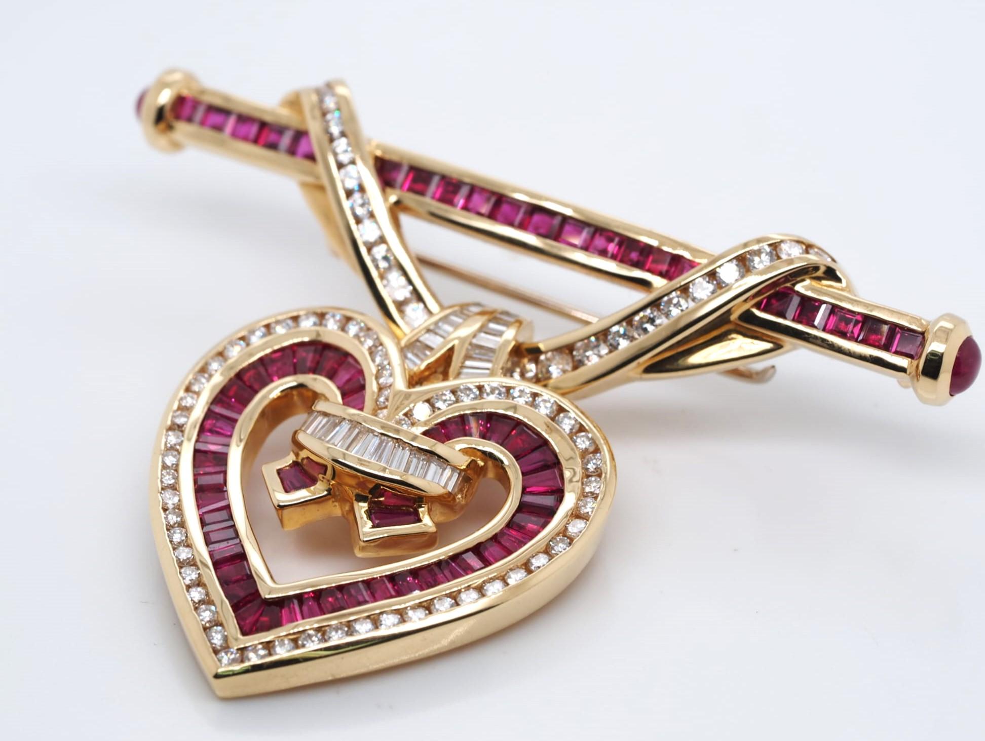A stunning piece of fine jewelry, this Charles Krypell brooch pin is crafted from 18KT yellow gold and features a heart-shaped natural ruby stone measuring 3.2 carats. The ruby is surrounded by 2.67 carats of brilliant white diamonds, all set in a