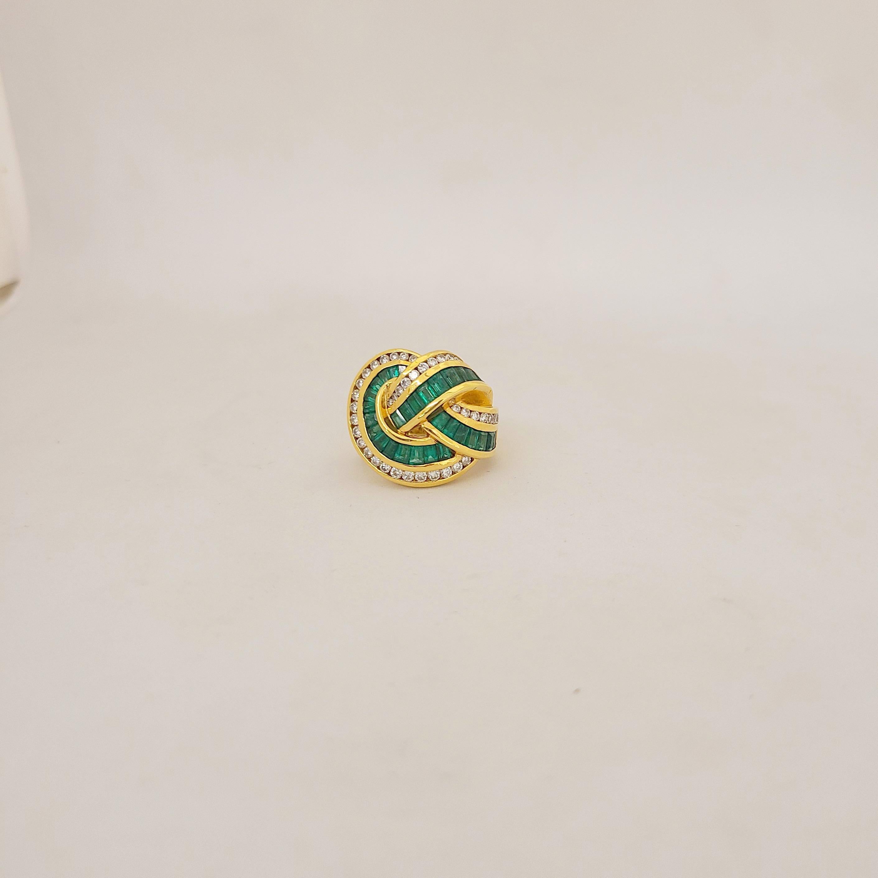 Made with superior quality by Charles Krypell, this ribbon knot design 18k yellow gold ring features 2.59 carats of vivid emeralds and 0.85 carats of high quality round brilliant diamonds - approximately F color, VS clarity. This makes a fabulous