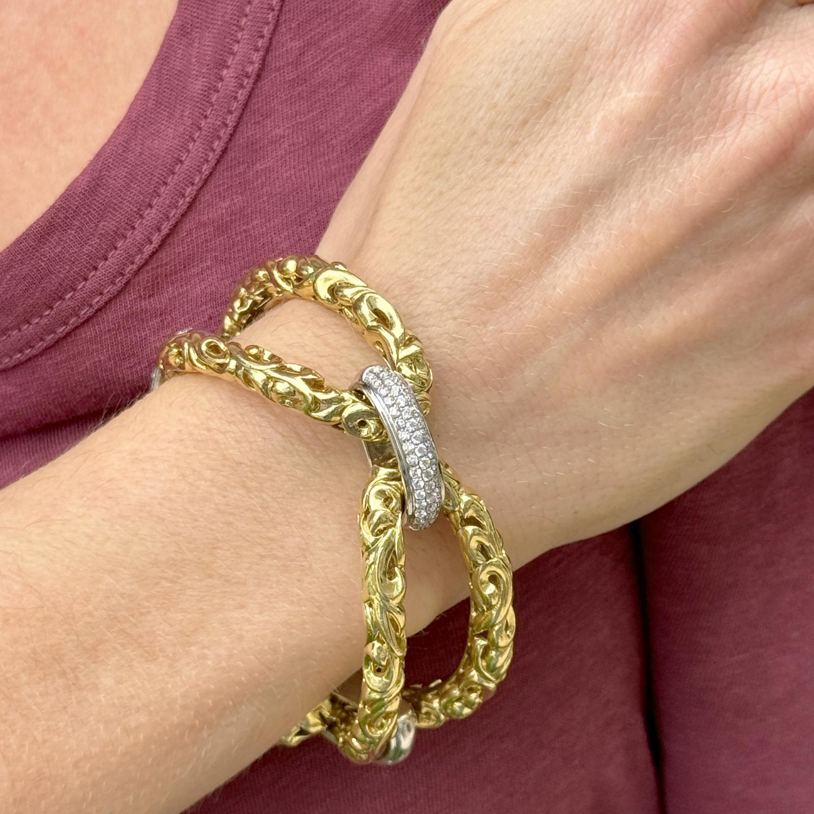 Large oval link diamond bracelet by designer Charles Krypell. The bracelet is crafted in 18 karat gold and features three stations set with 57 round brilliant cut diamonds weighing approximately 1.85 carat total weight. The diamonds are graded F-G