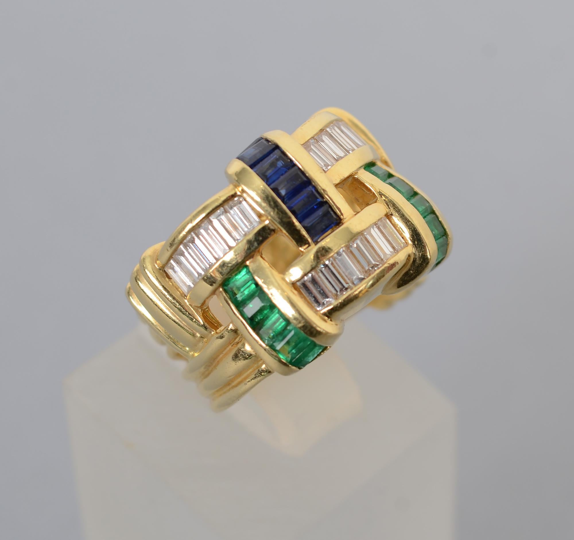 Charles Krypell wide band ring of diamonds; sapphires and emeralds. Krypell is well known for the fine quality of the stones he used.  The baguette stones are set in a design to appear as though they are interwoven.
The ring measures 5/8