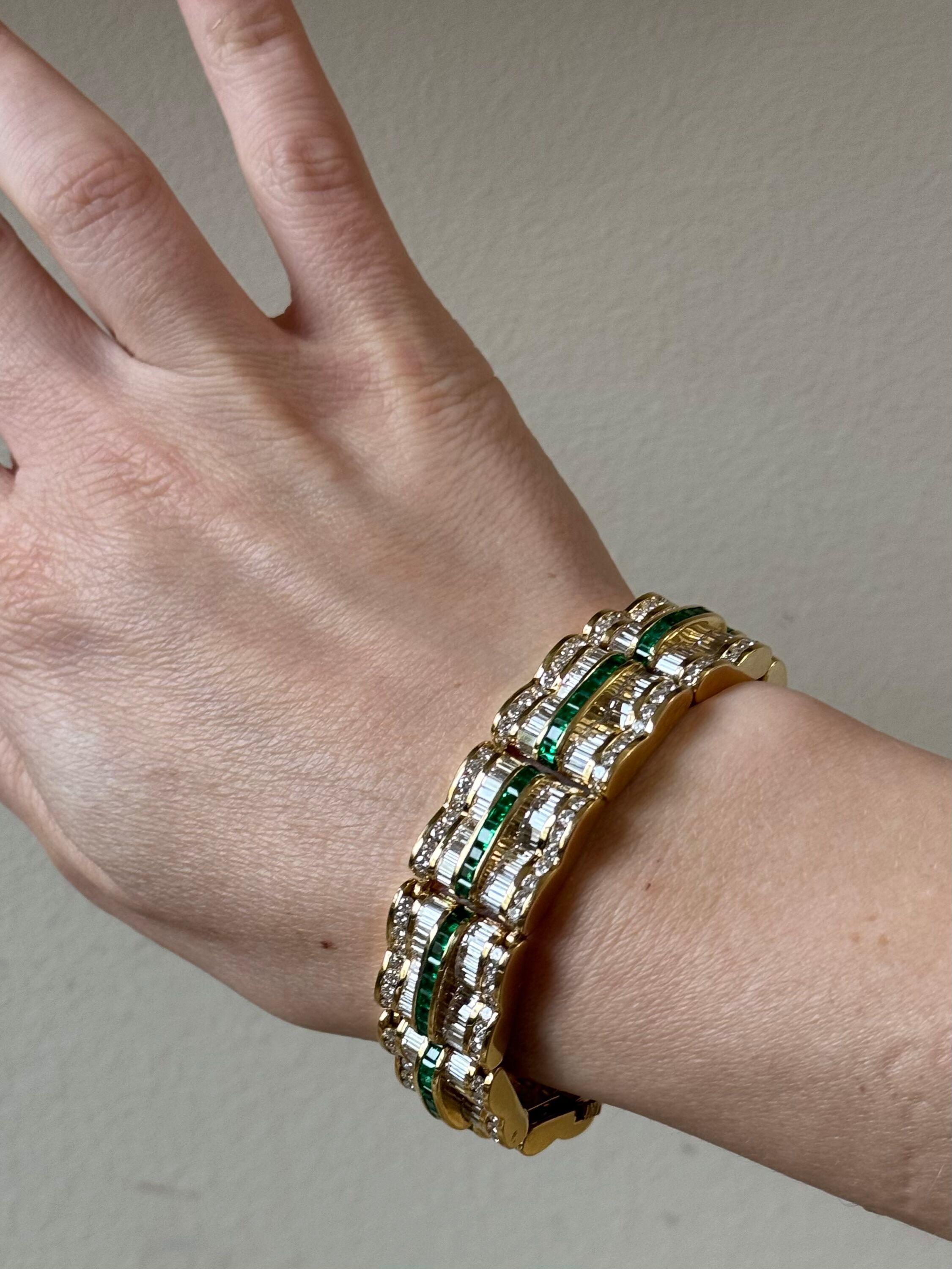 An impressive 18k yellow gold bracelet by Charles Krypell, adorned with an approximately 18 carats in baguette and round diamonds, G/VS, and emeralds. Bracelet is 7 1/18