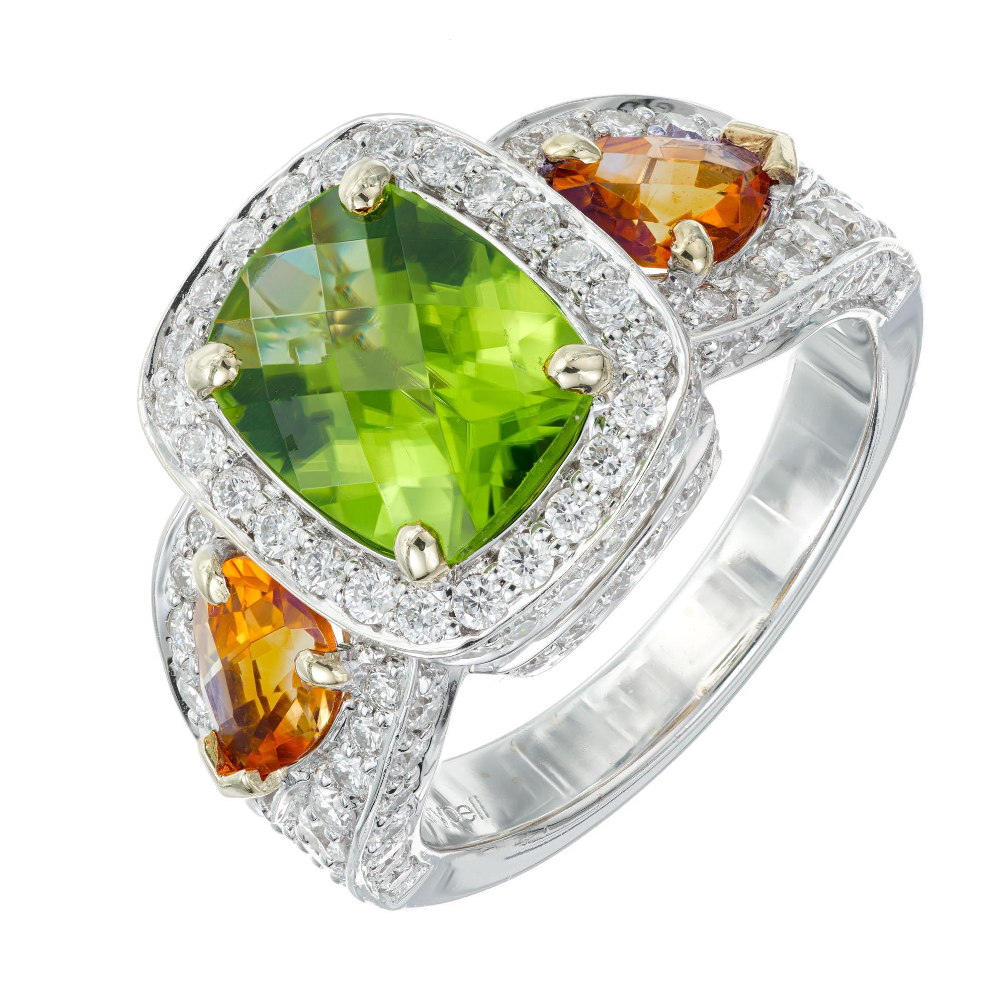 Authentic Charles Krypell Peridot Citrine diamond cocktail ring. 2.80 carat peridot center stone with a halo of 135 full cut diamonds and 2 pear shaped orange citrine in a 18k white gold setting.

1 cushion Peridot 10 x 8mm. approx. total weight