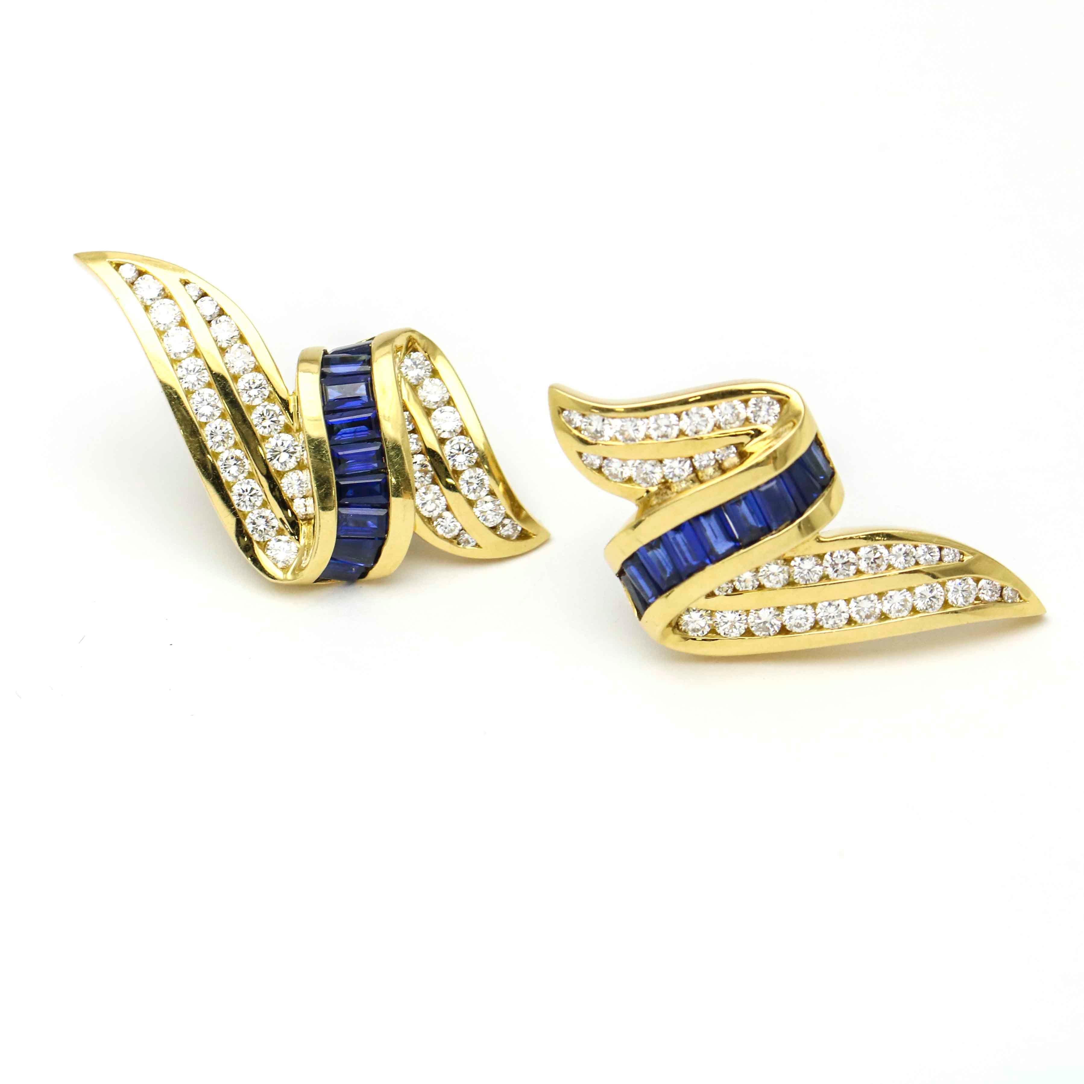 Elegant diamond and blue sapphire ribbon motif earclips by Charles Krypell. The earrings are crafted in 18 karat yellow gold channel-set with round diamonds and baguette-cut natural sapphires. 