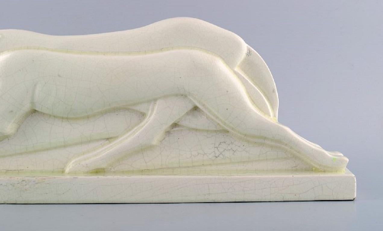 Charles Lemanceau (1905-1980), French sculptor. Art deco sculpture of greyhounds in glazed faience. 
1930s / 40s.
Measures: 43 x 16.5 x 5 cm.
In excellent condition.
Signed.