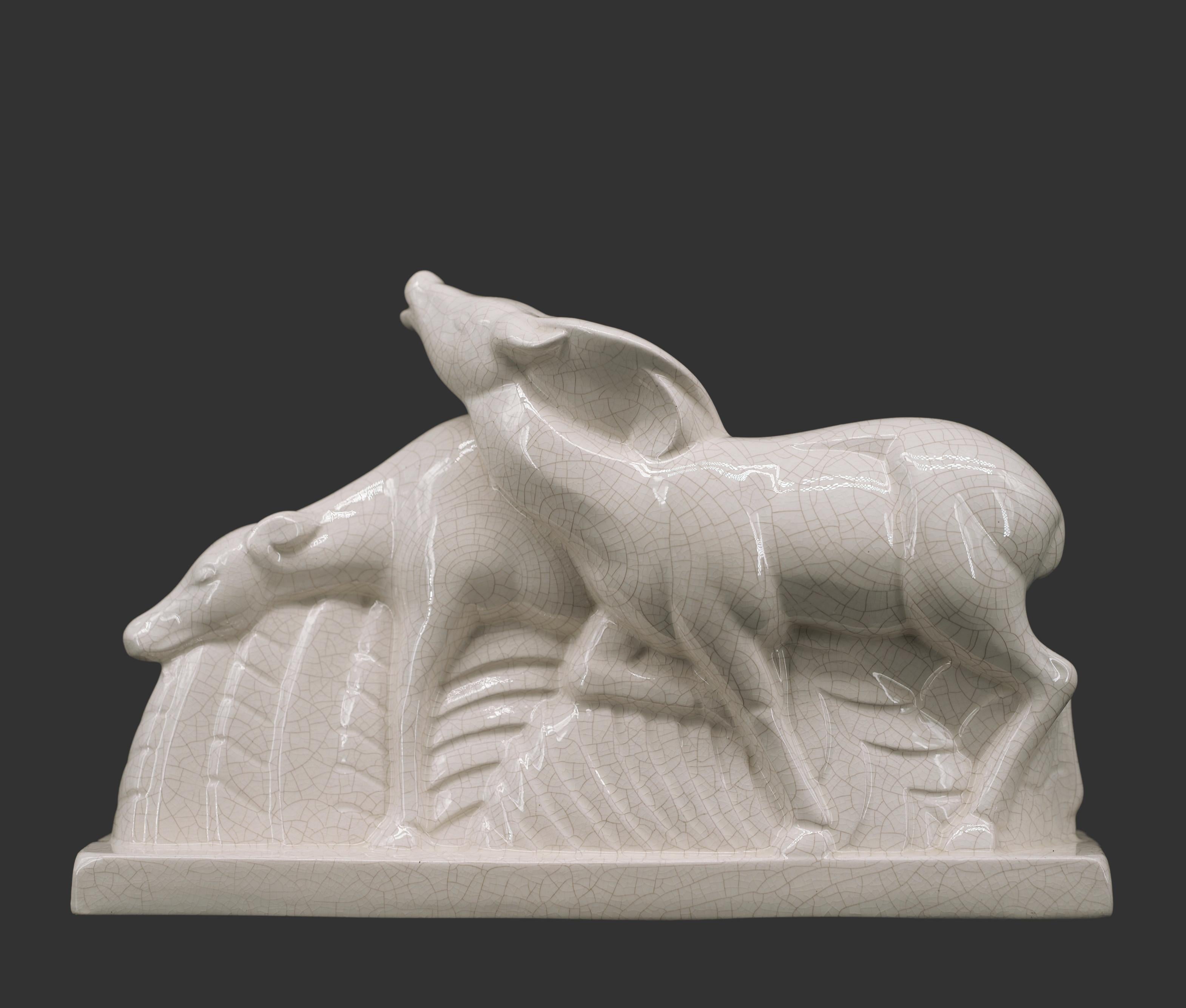 French Art Deco couple of does by Charles LEMANCEAU at Saint-Clément's for Le Bon Marché, France, 1920s. Illustrated in the Saint-Clément's catalog, 1925, page #1 under the number #1. Crackle glaze ceramic.  Width: 14