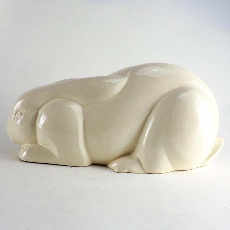 Charles Lemanceau for saint-clement white crackle glaze faience rabbit, circa 1929.

Lapin Couche. A charming sculpture from this style-defining French artist and master craftsman who combined the characteristic linear and cubistic forms of the