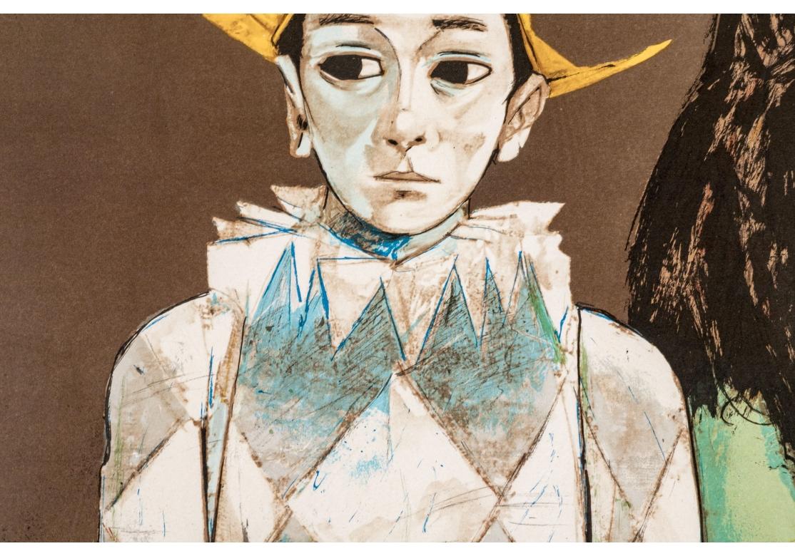 Lithografie, die einen Harlekin darstellt, der Schulter an Schulter mit einer Frau steht, die einen blauen Vogel in der Hand hält.
Limitierte Auflage von 250 Stück unten links.
Signiert unten rechts.
Präsentiert in einem goldfarbenen Metallrahmen,