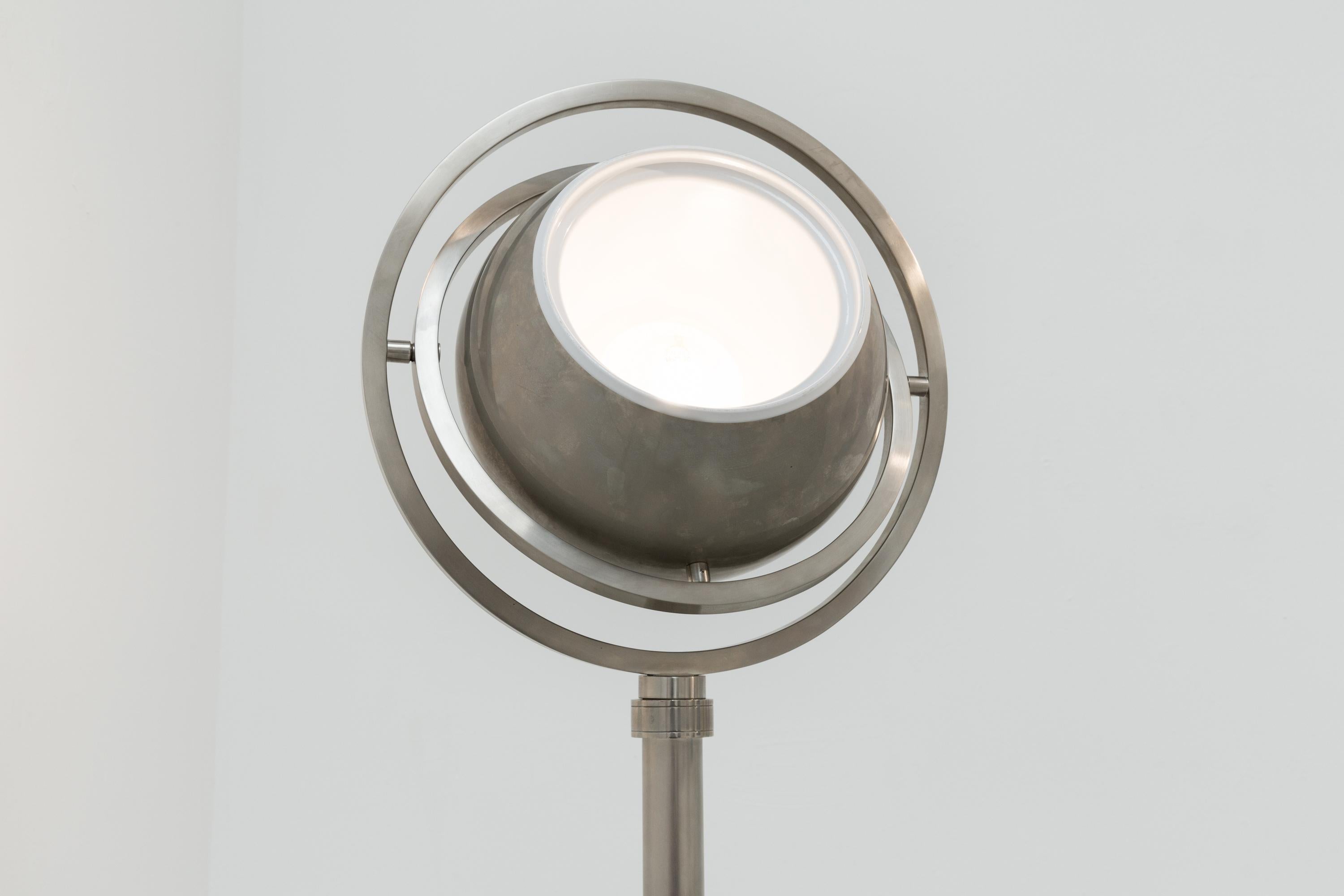 A floor lamp by Charles Martin, nickeled metal. One floodlight that can be turned in many directions. Production and year unknown.