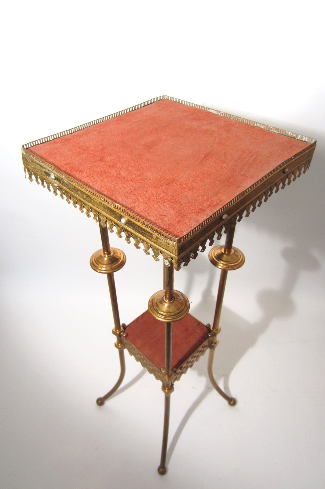 American Aesthetic bronze pedestal table by Charles Parker, circa 1870-1890 
Bronze skirt and tubular legs with ball feet.
Label on bottom of top shelf marked ~The Chas. Parker CO Meriden, Conn.~.