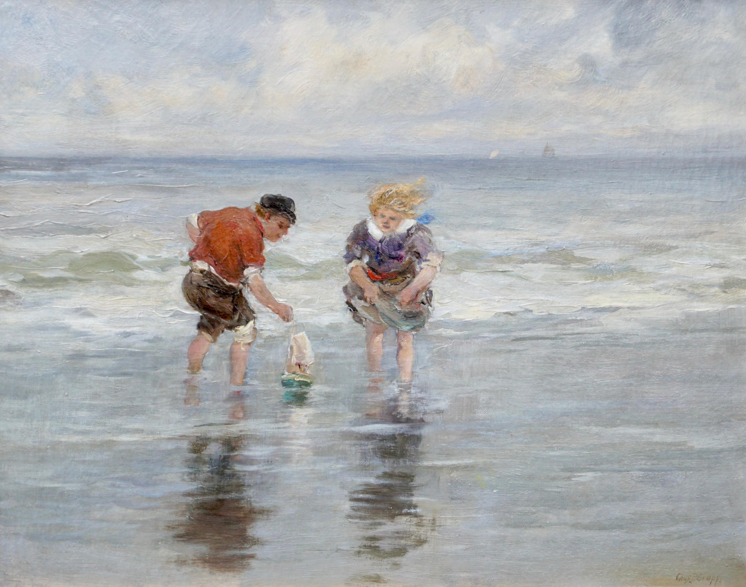 Charles Paul Gruppe (American, 1860-1940). A delightful and cheerful 19th century scene of a young boy and girl playing with a toy sailboat in a tidal pool at the beach with ocean waves braking behind them. Faint sailboats on the horizon with sun